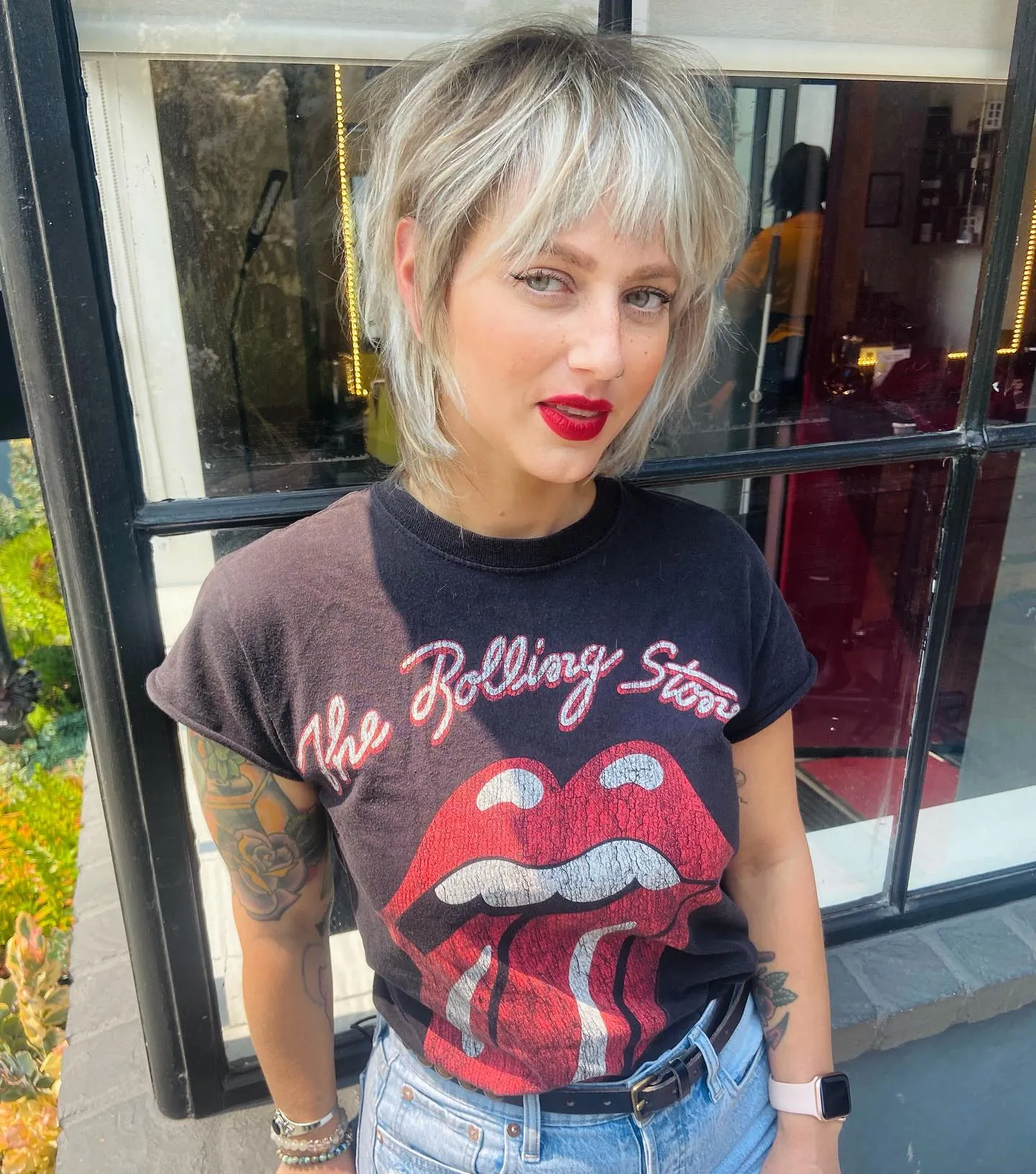 Blonde short shag with light wispy bangs and longer nape layers