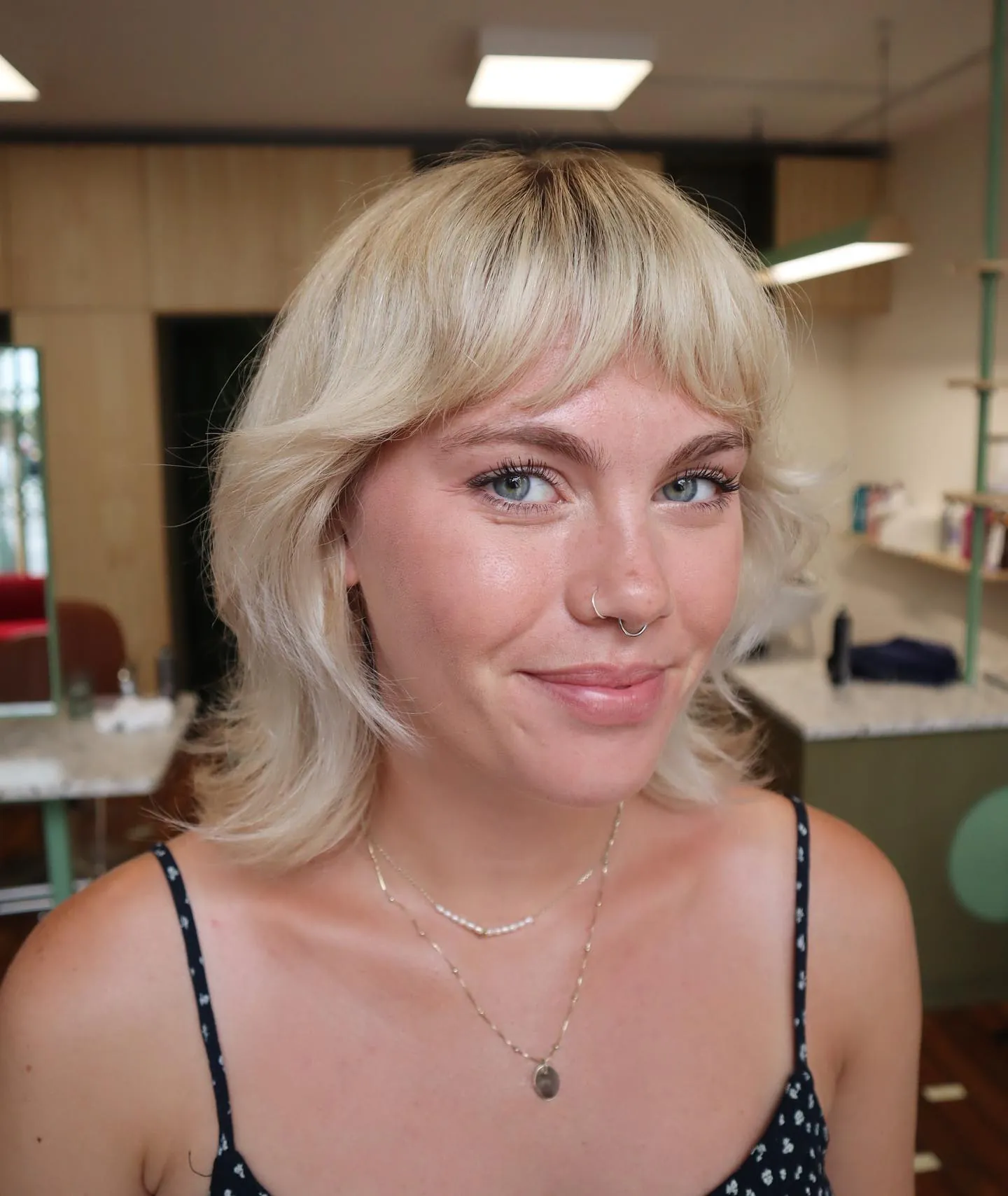 Feathered blonde short shag with curved bangs and flicked ends