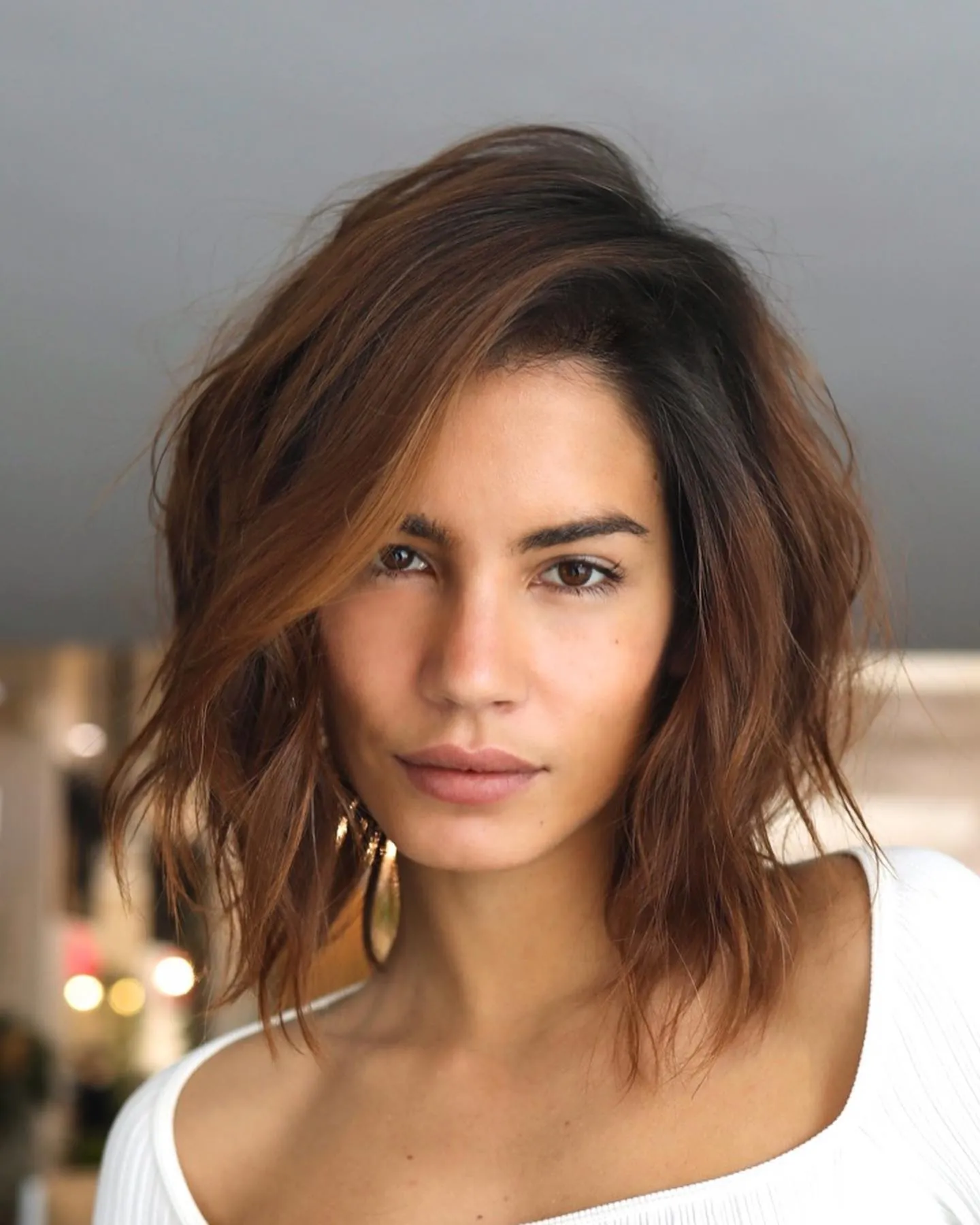 Layered auburn wavy lob with side-swept volume