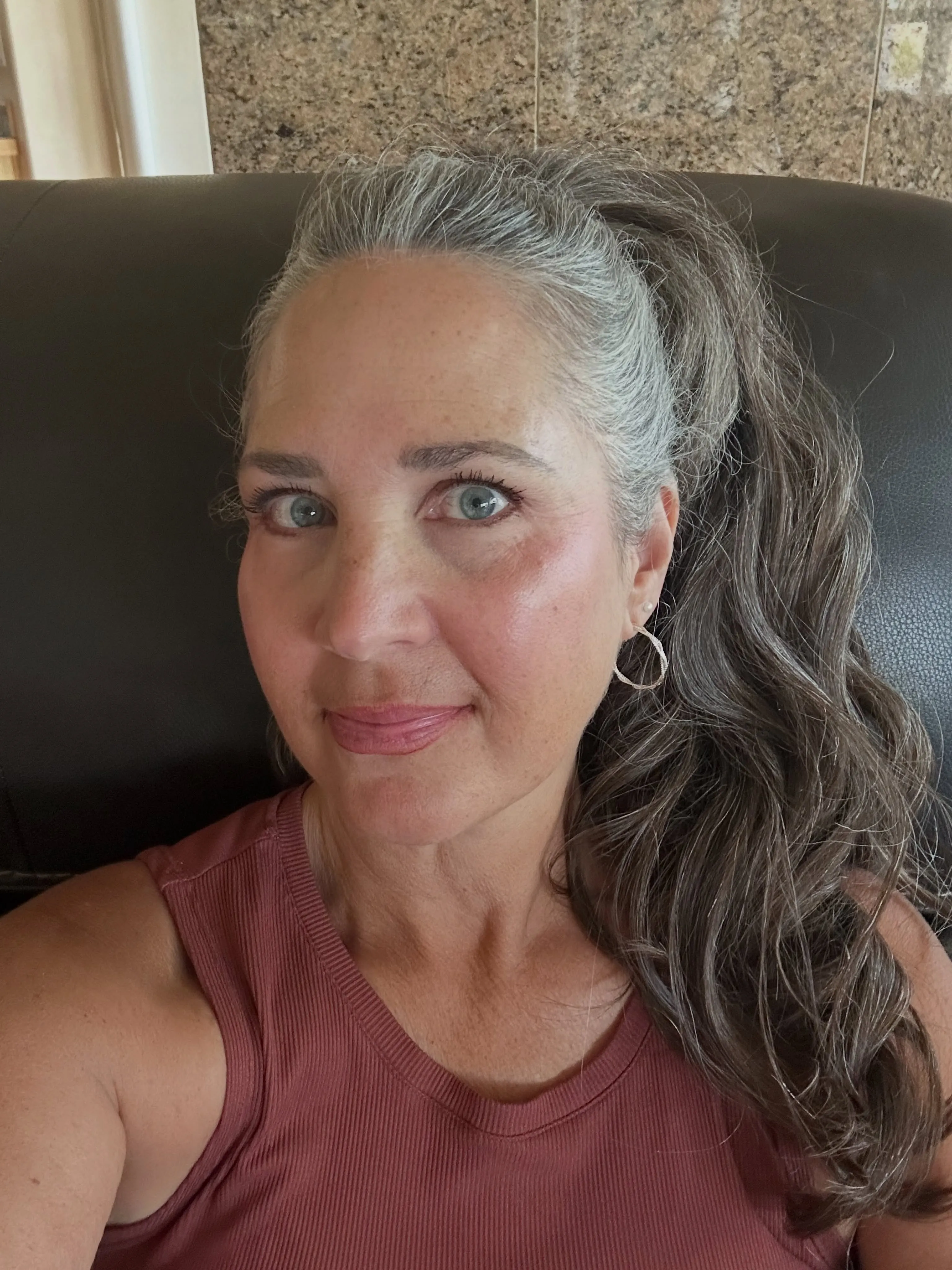 Silver wavy hair styled half up