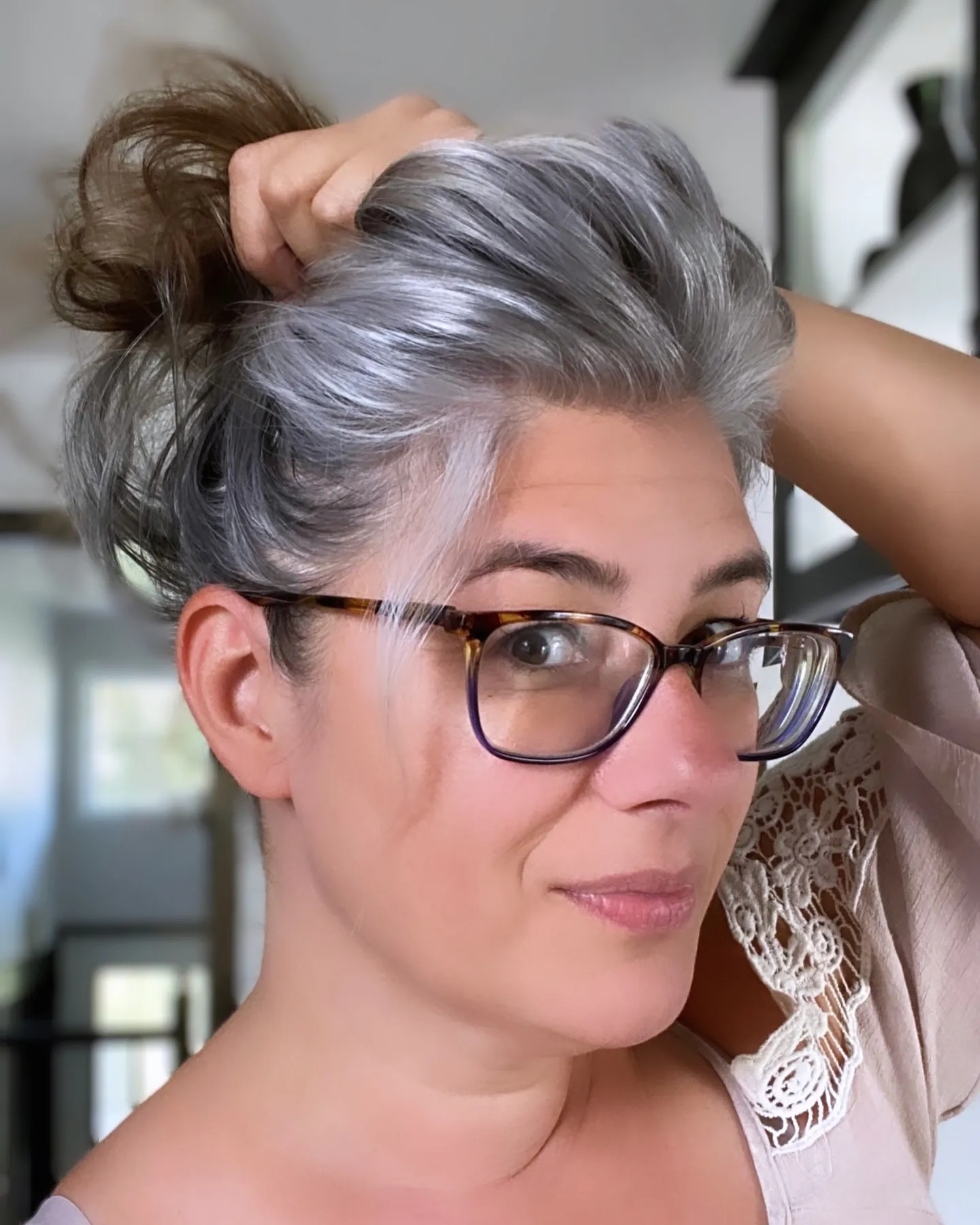 Short silver hair brushed back with lift