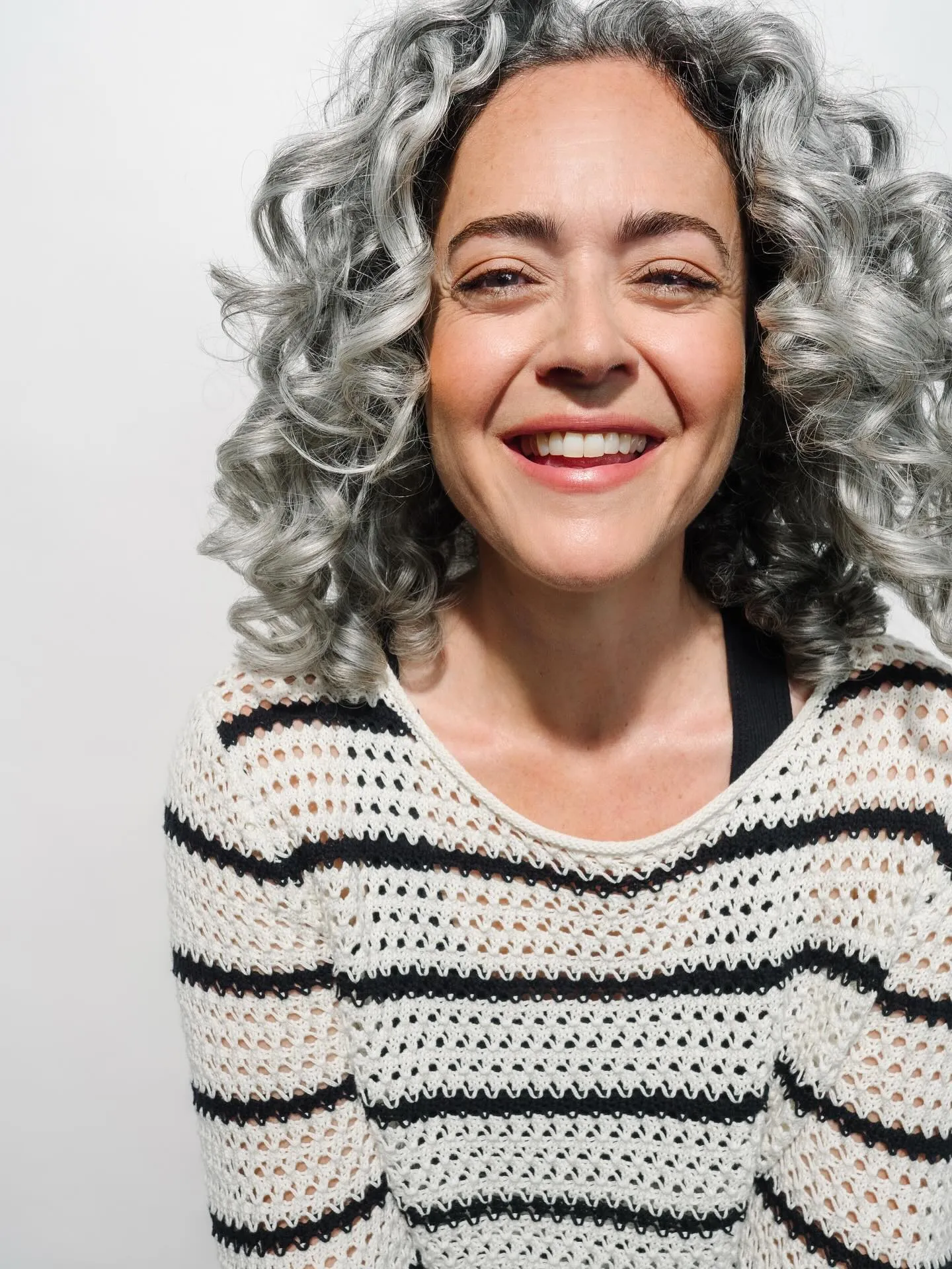 Curly silver bob with full rounded volume