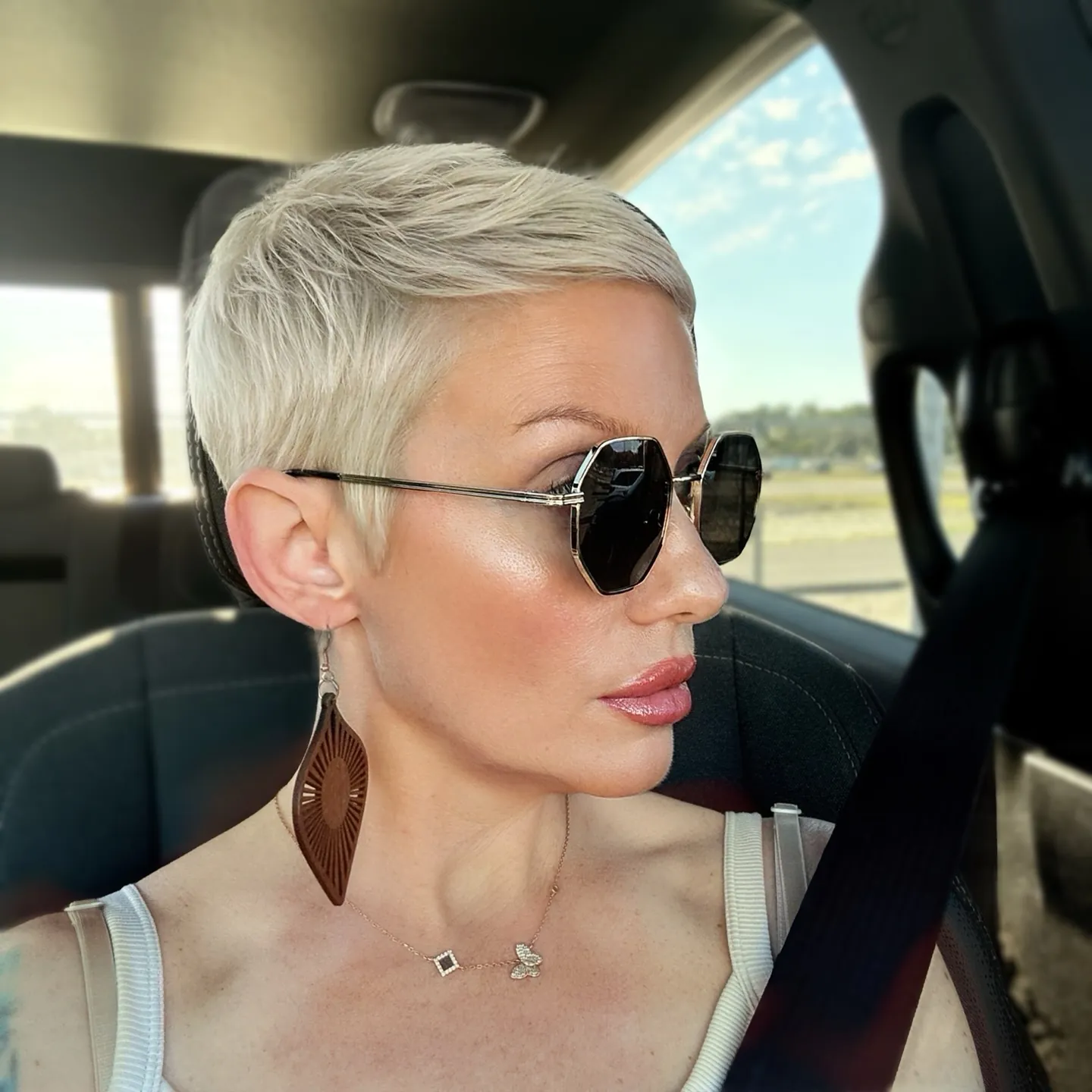 Platinum pixie with sleek side-swept top and short sides