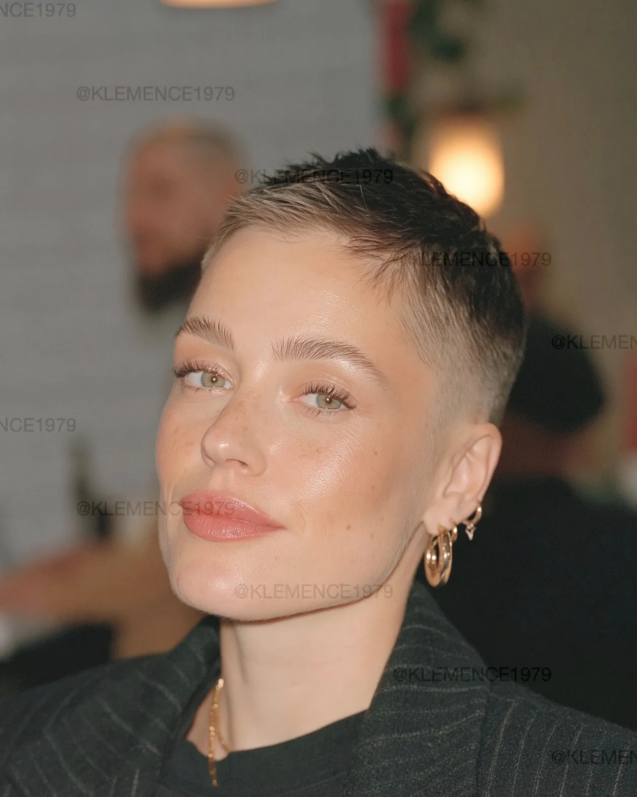 Very short dark pixie slicked close to the head