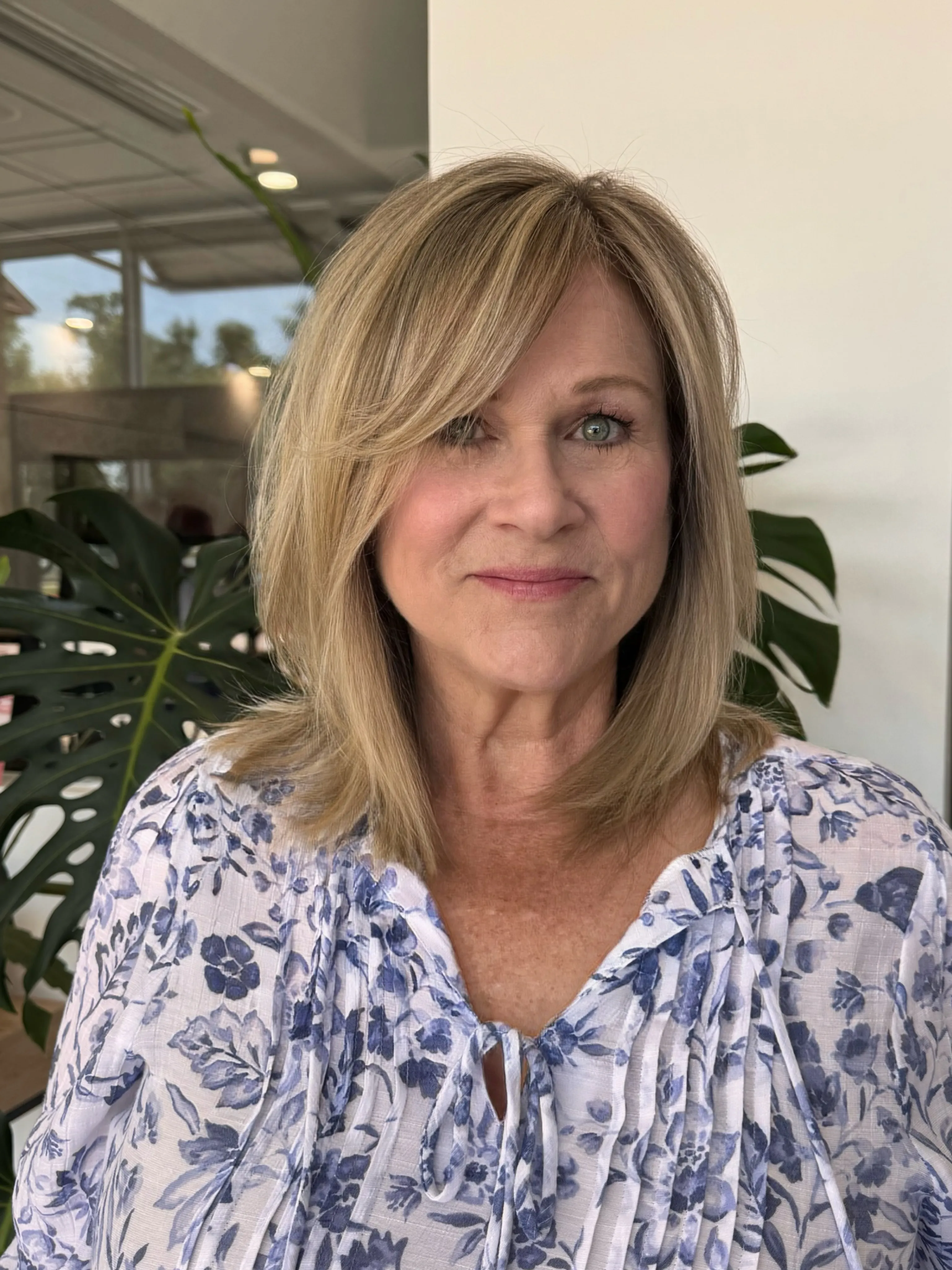 Side-parted layered lob with smooth rounded volume