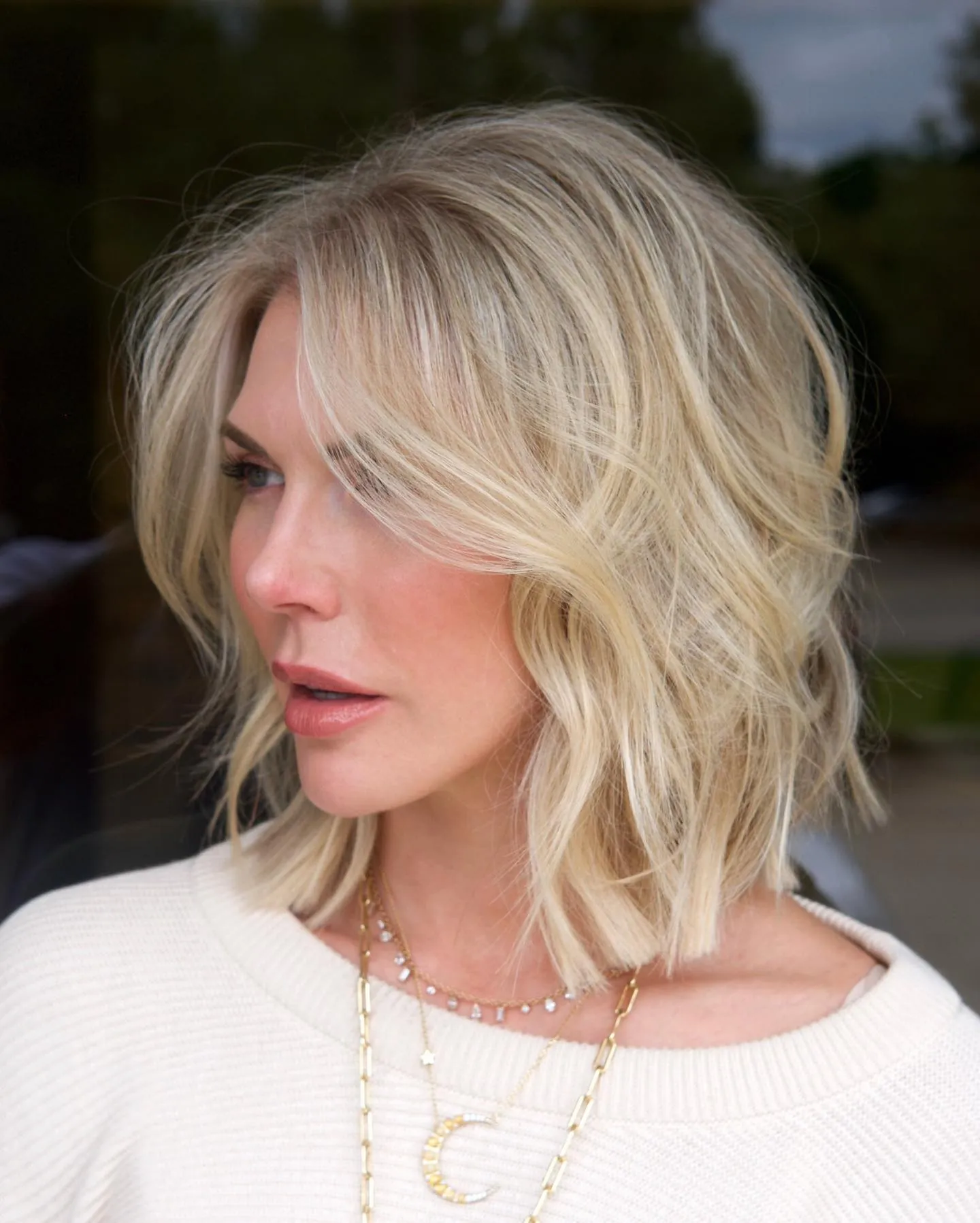 Soft blonde layered lob with side-swept front pieces