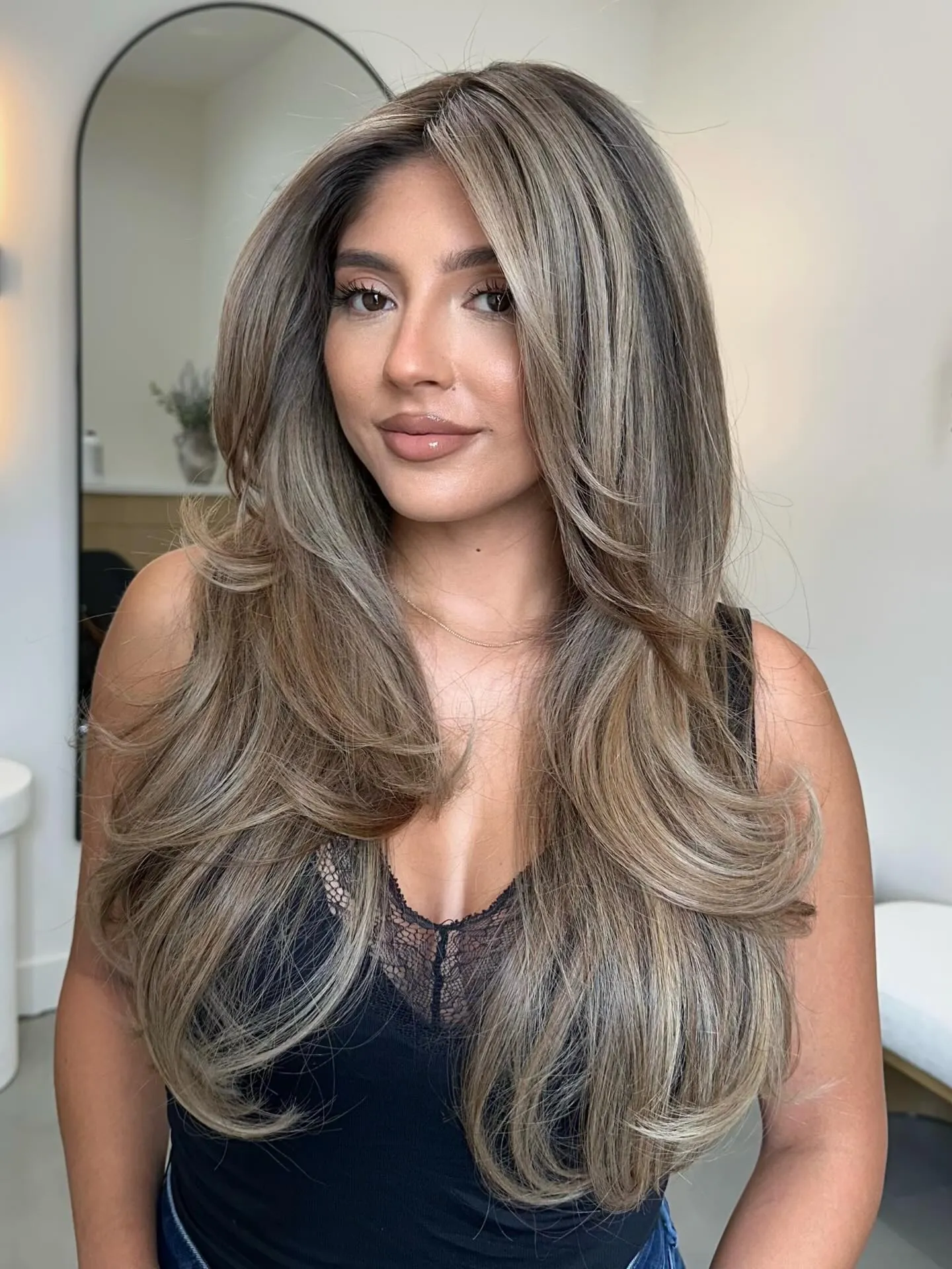 Long dimensional suede blonde layers with soft root shadow