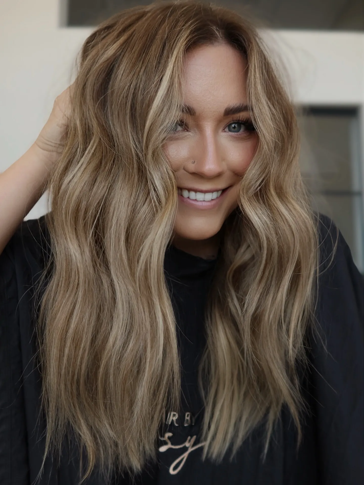 Tousled suede blonde waves with center part and airy texture