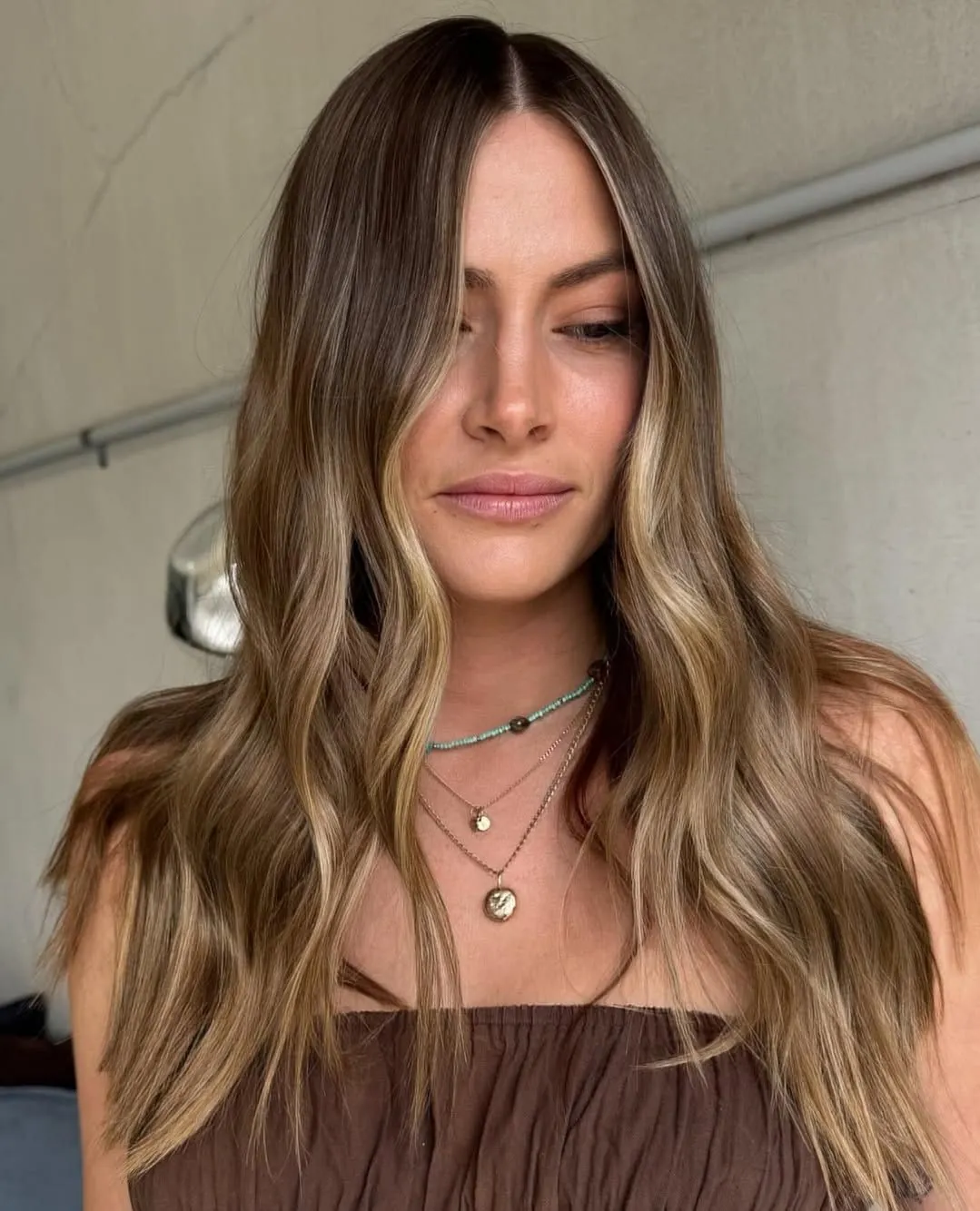 Rooted suede blonde hair with soft mid-length waves