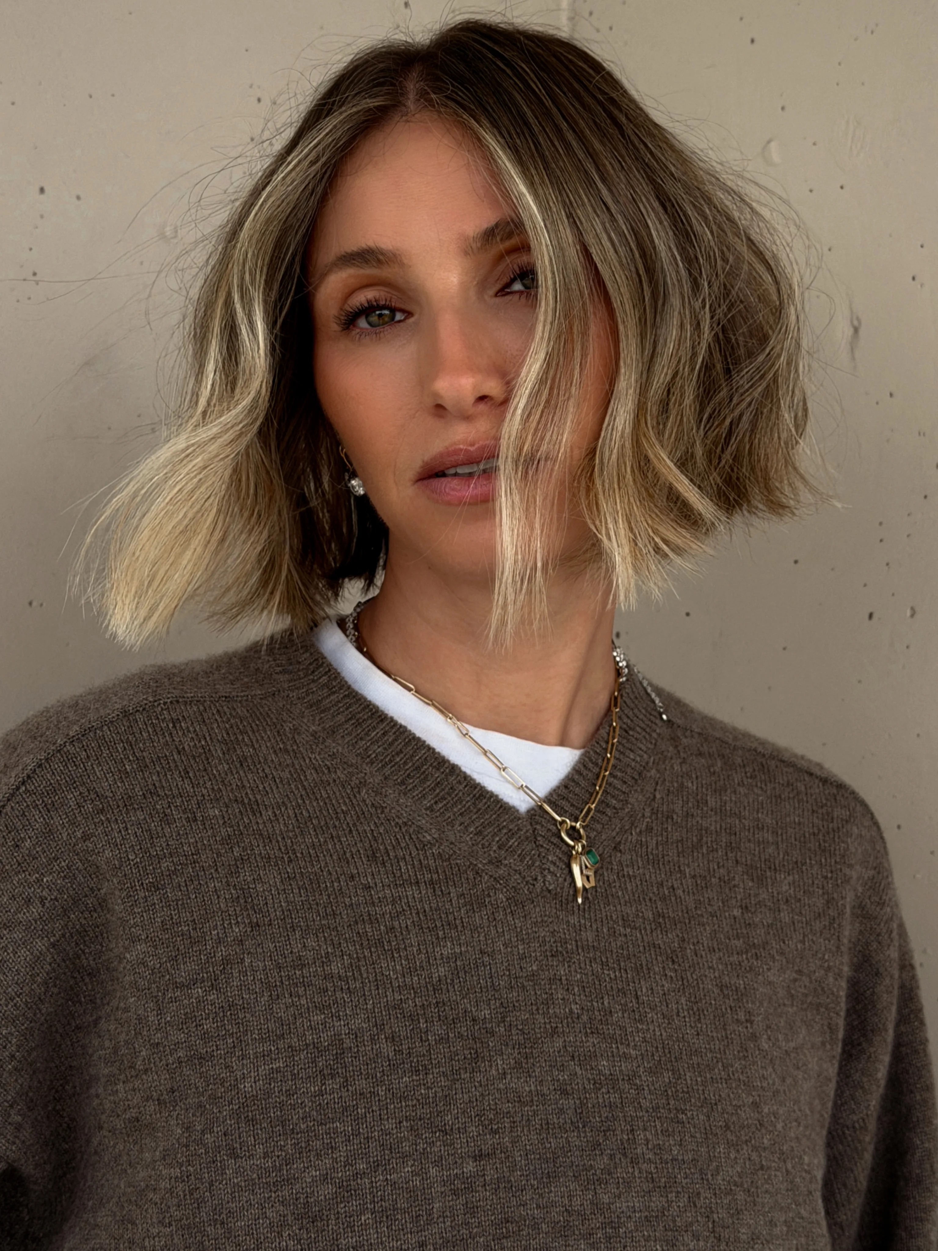 Textured suede blonde lob with darker roots and soft waves