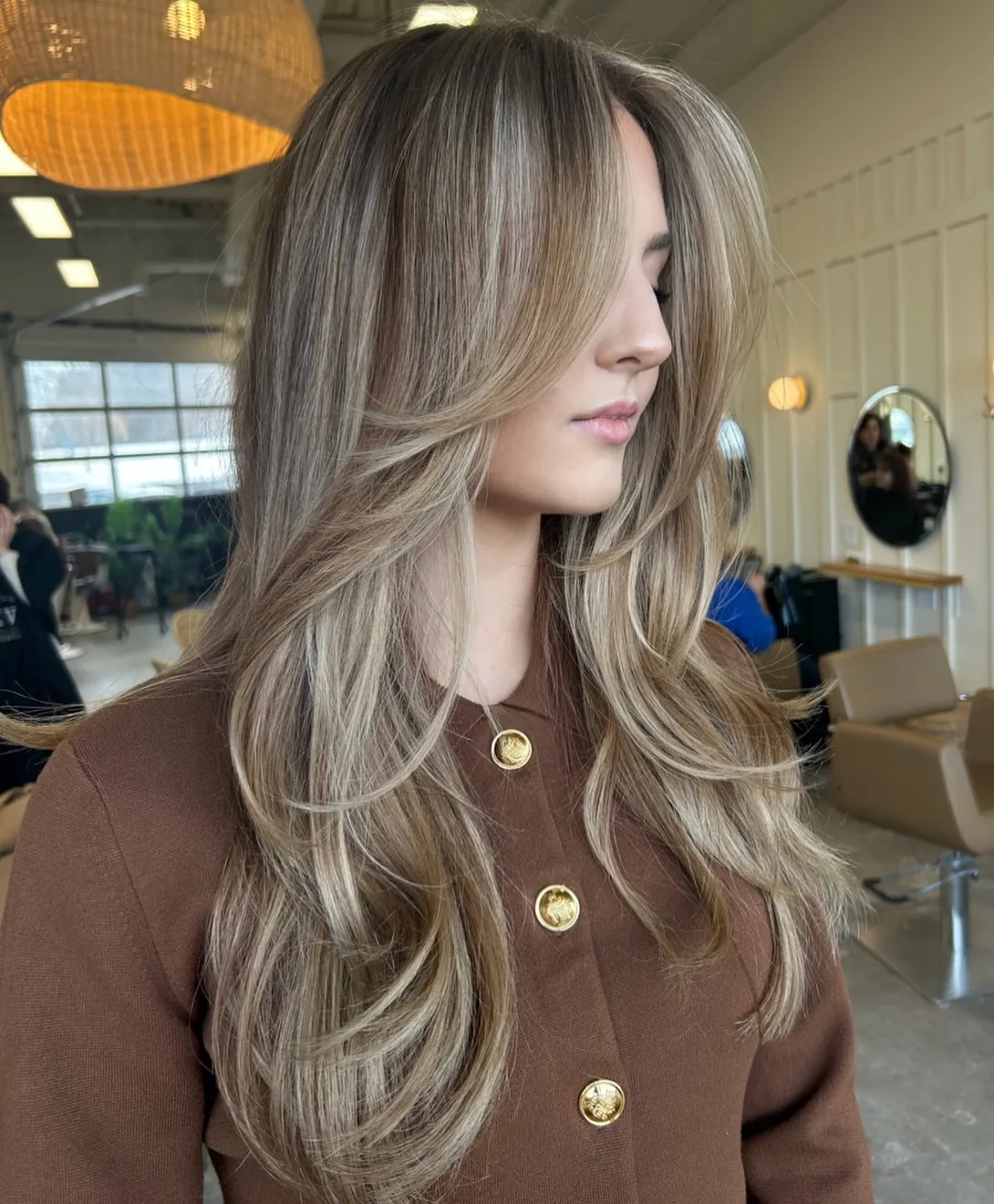 Cool suede blonde layers with smooth face-framing blowout