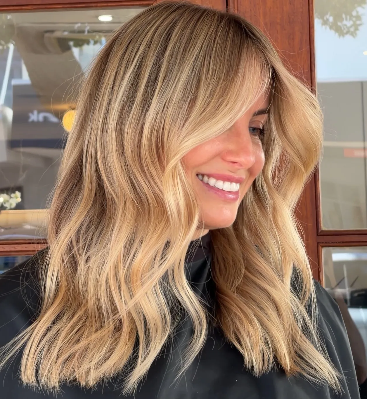 Suede blonde shoulder lob with loose waves and center part