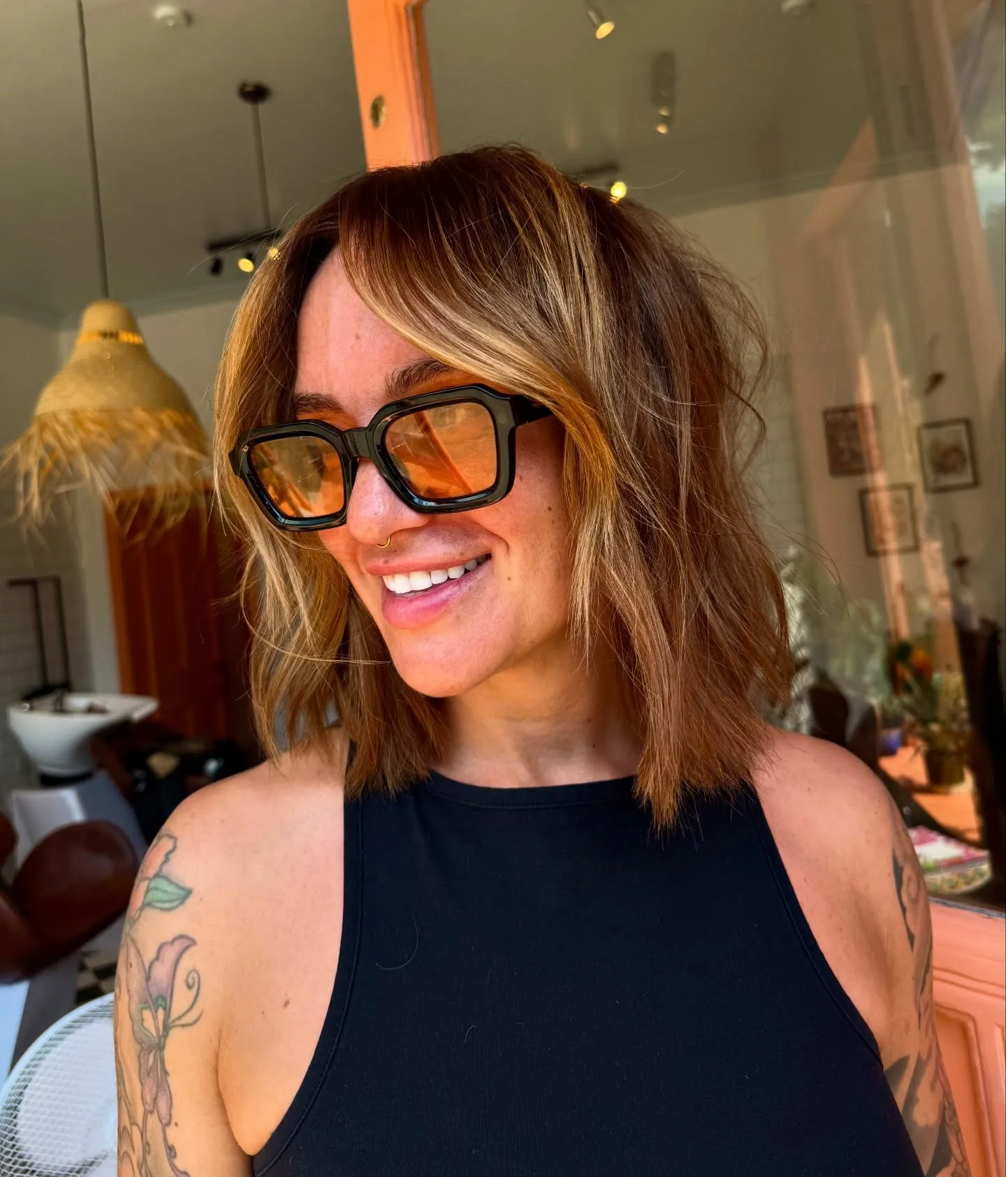 Warm suede blonde bob with darker root and straight ends