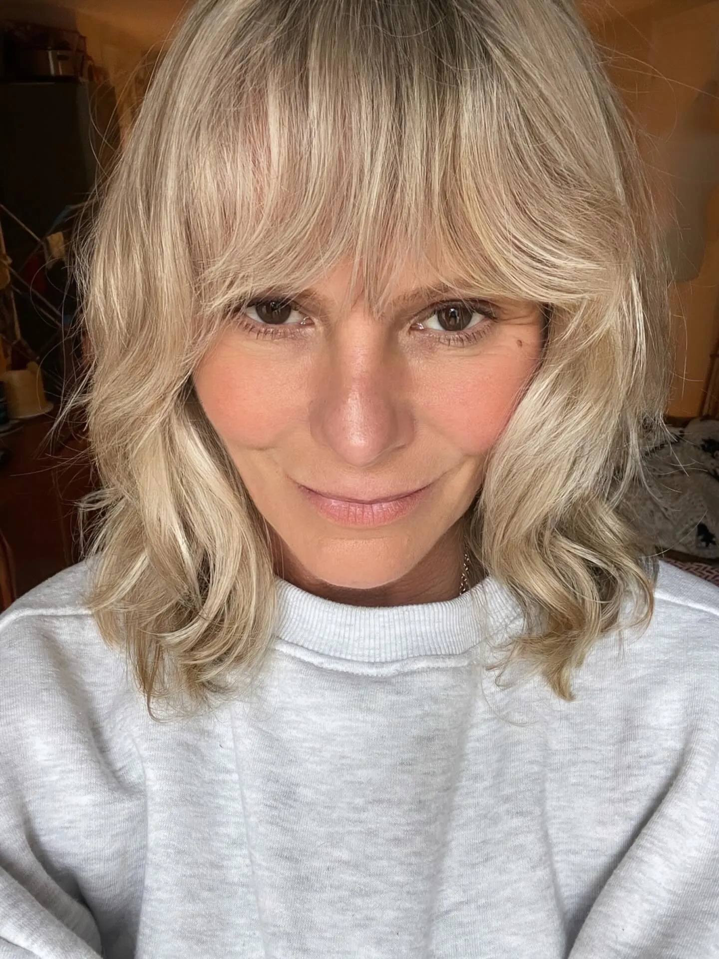 Blonde lob with curtain bangs and soft waves
