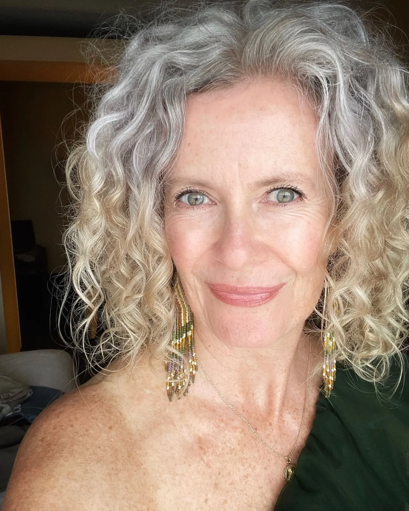Short silver curly bob with side-parted volume