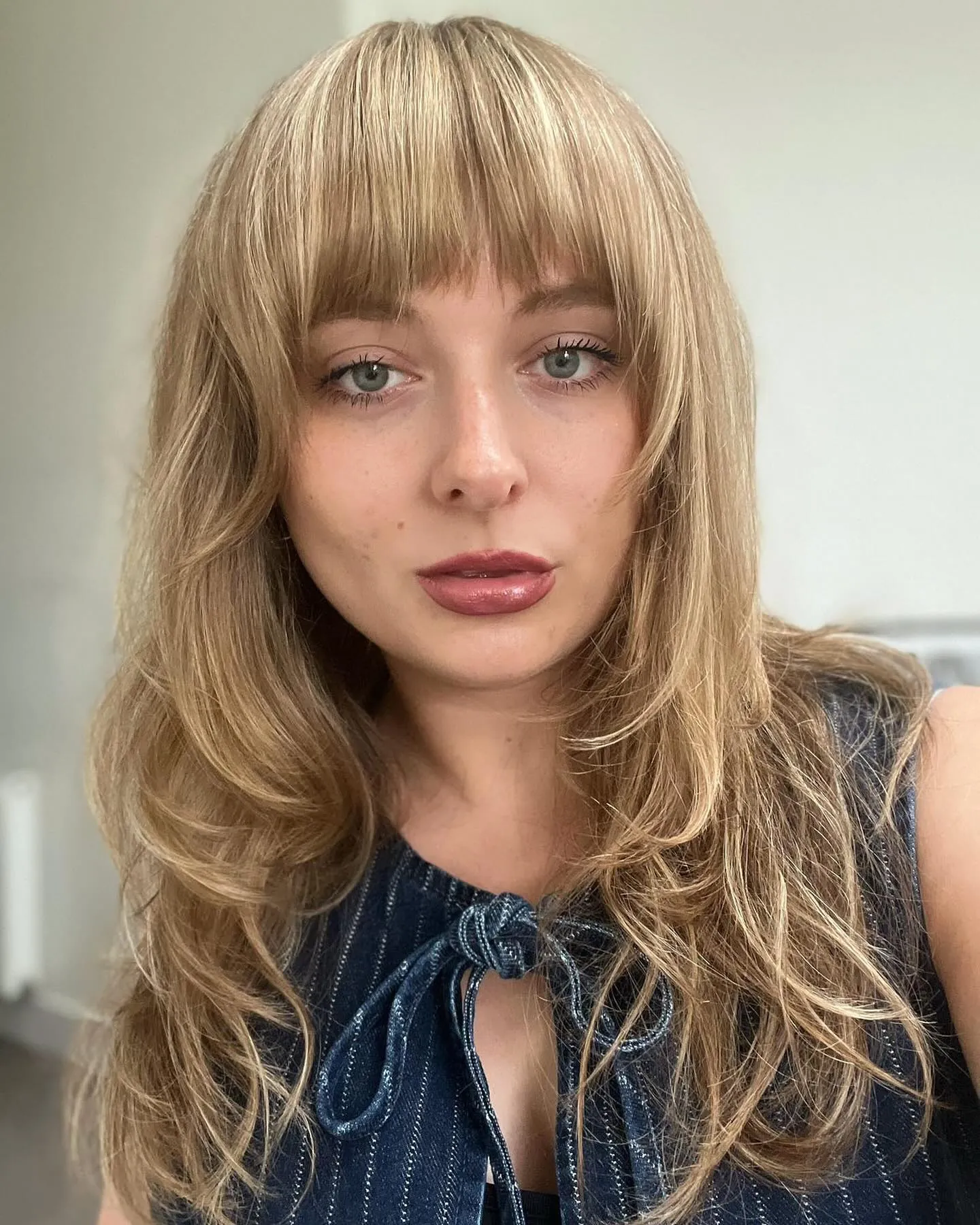Long blonde layers with full straight fringe