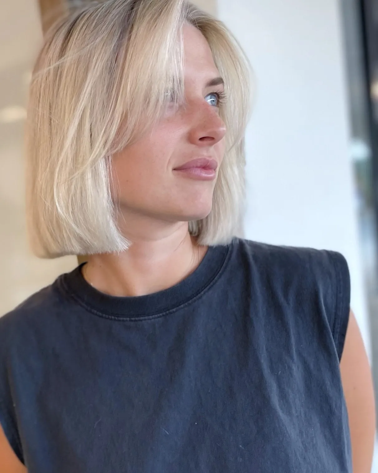 Clean blunt blonde bob with side part
