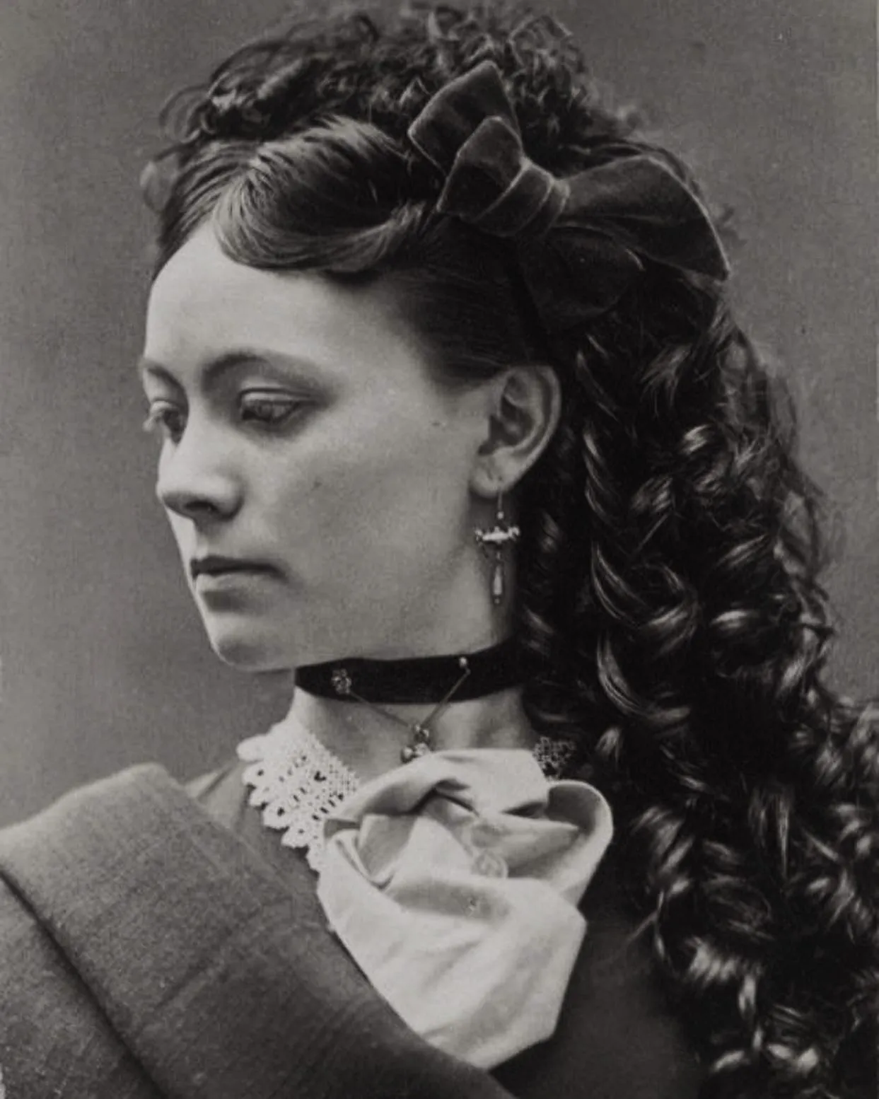Victorian hairstyle with smooth front rolls and long side ringlets
