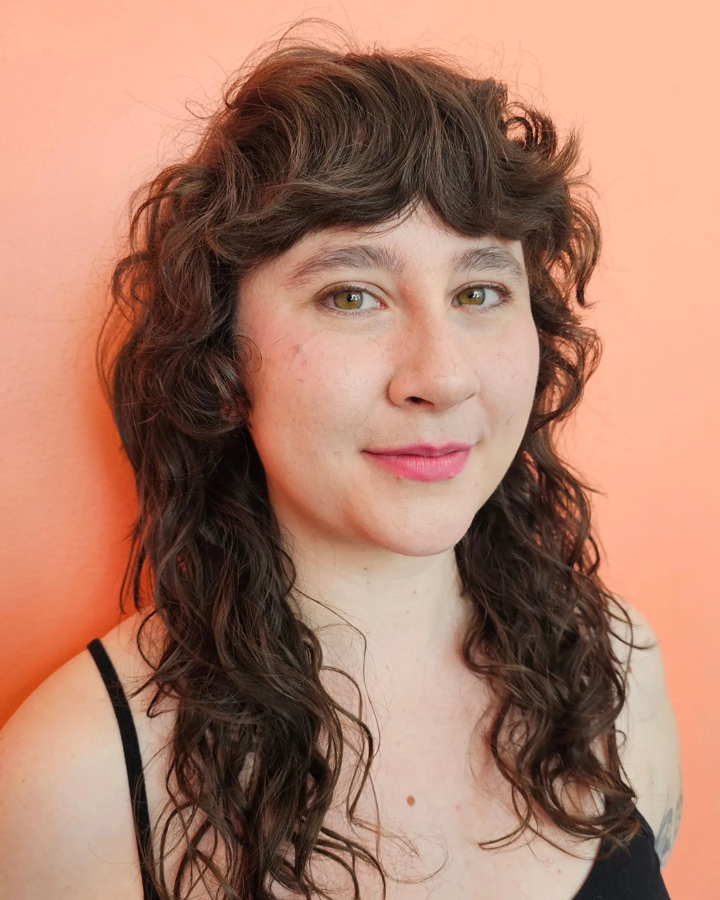Long curly hair with short Victorian-inspired fringe and face curls