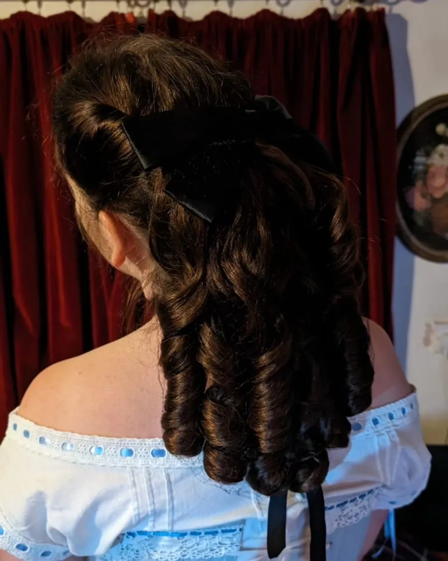 Dark Victorian updo with long ringlets falling down the back