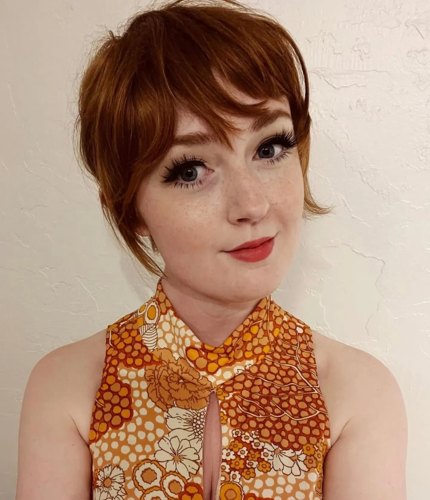 Short auburn pixie with curled vintage fringe and side pieces