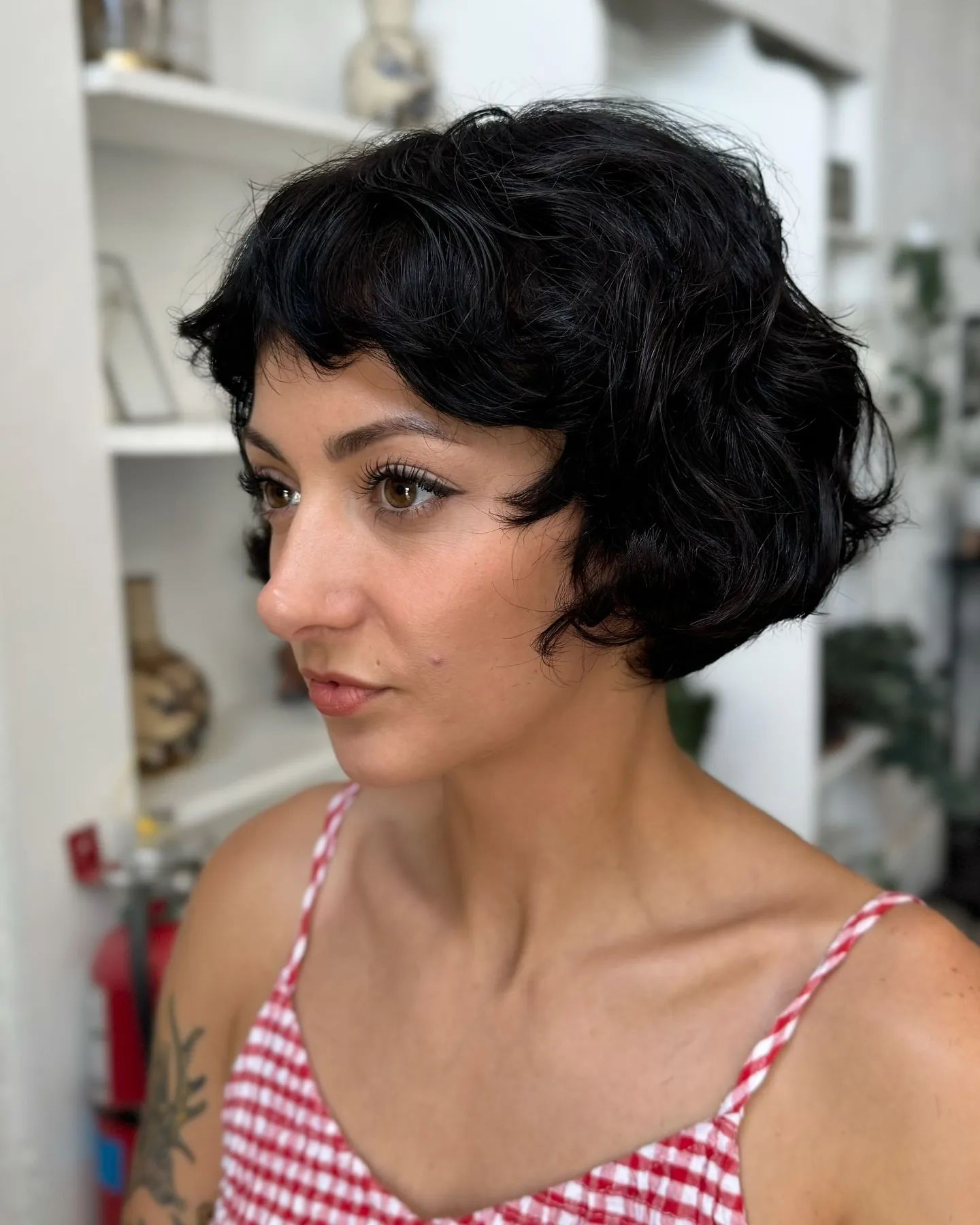 Short black bob with soft finger-wave texture around the sides