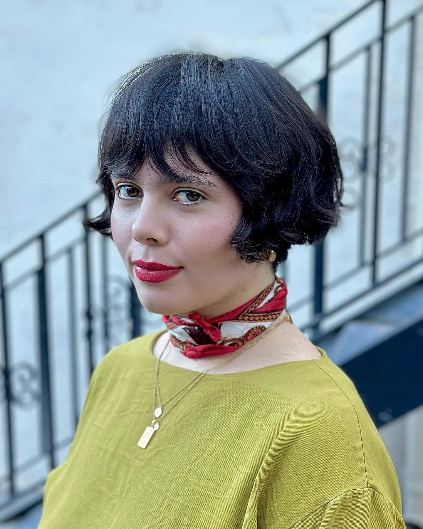 Dark rounded pageboy bob with full fringe and curved ends