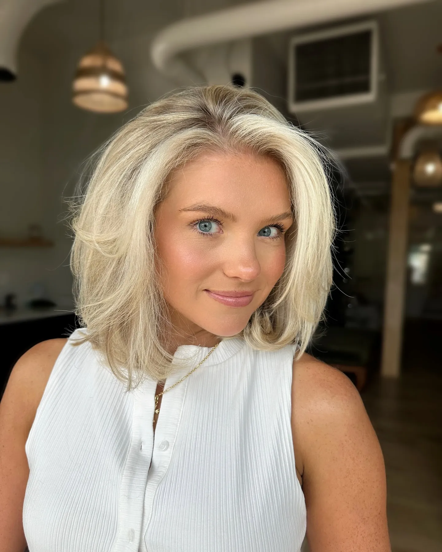 Blonde short bob with lifted crown and softly curved ends