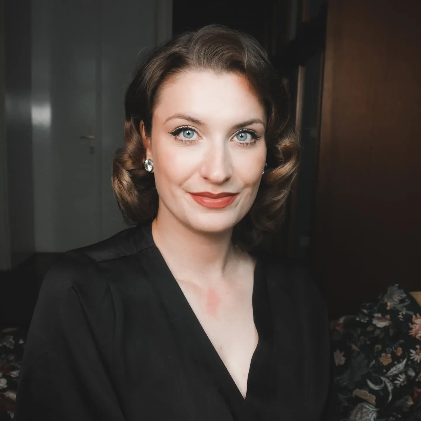 Short dark bob with smooth rolled curls at both sides