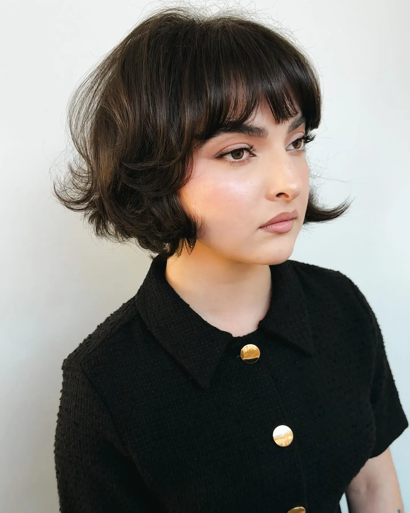 Dark bob with full fringe and flipped-out ends