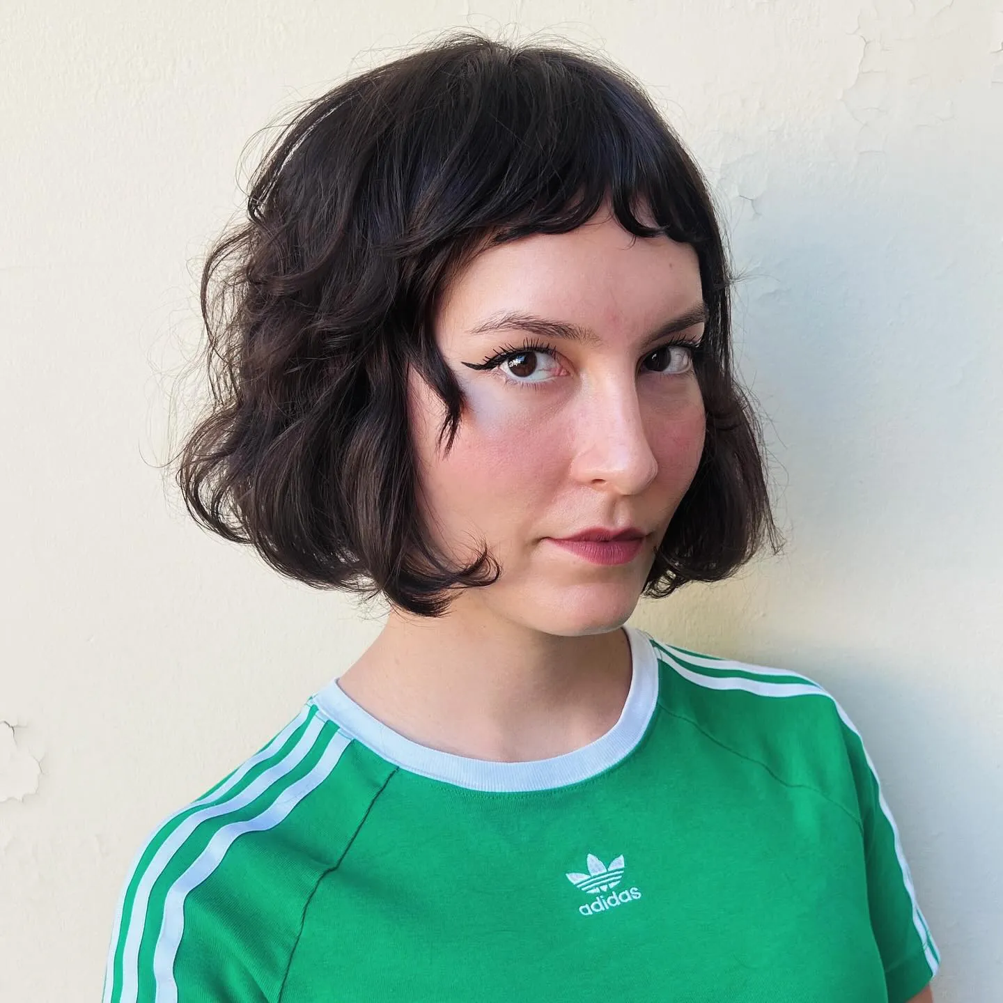 Short dark bob with baby bangs and curled ends