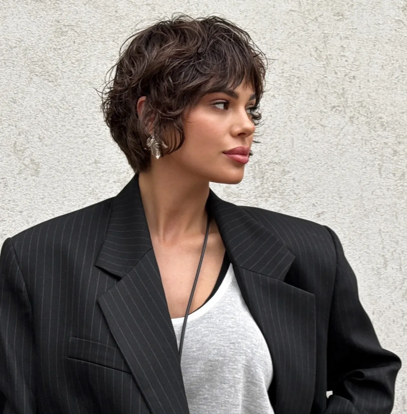 Short dark pixie with full vintage waves and side volume