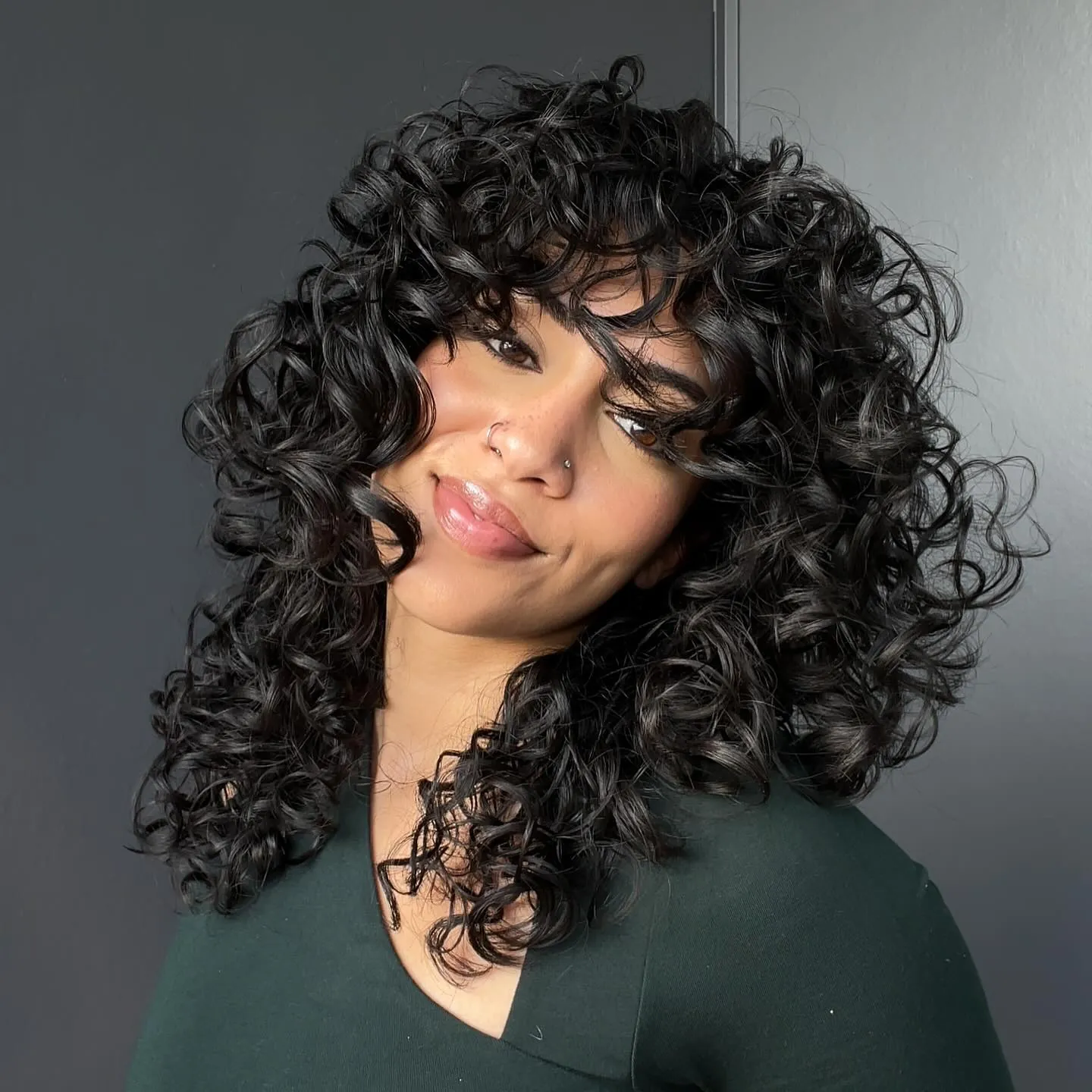 Shoulder-length curly lob with full curly fringe