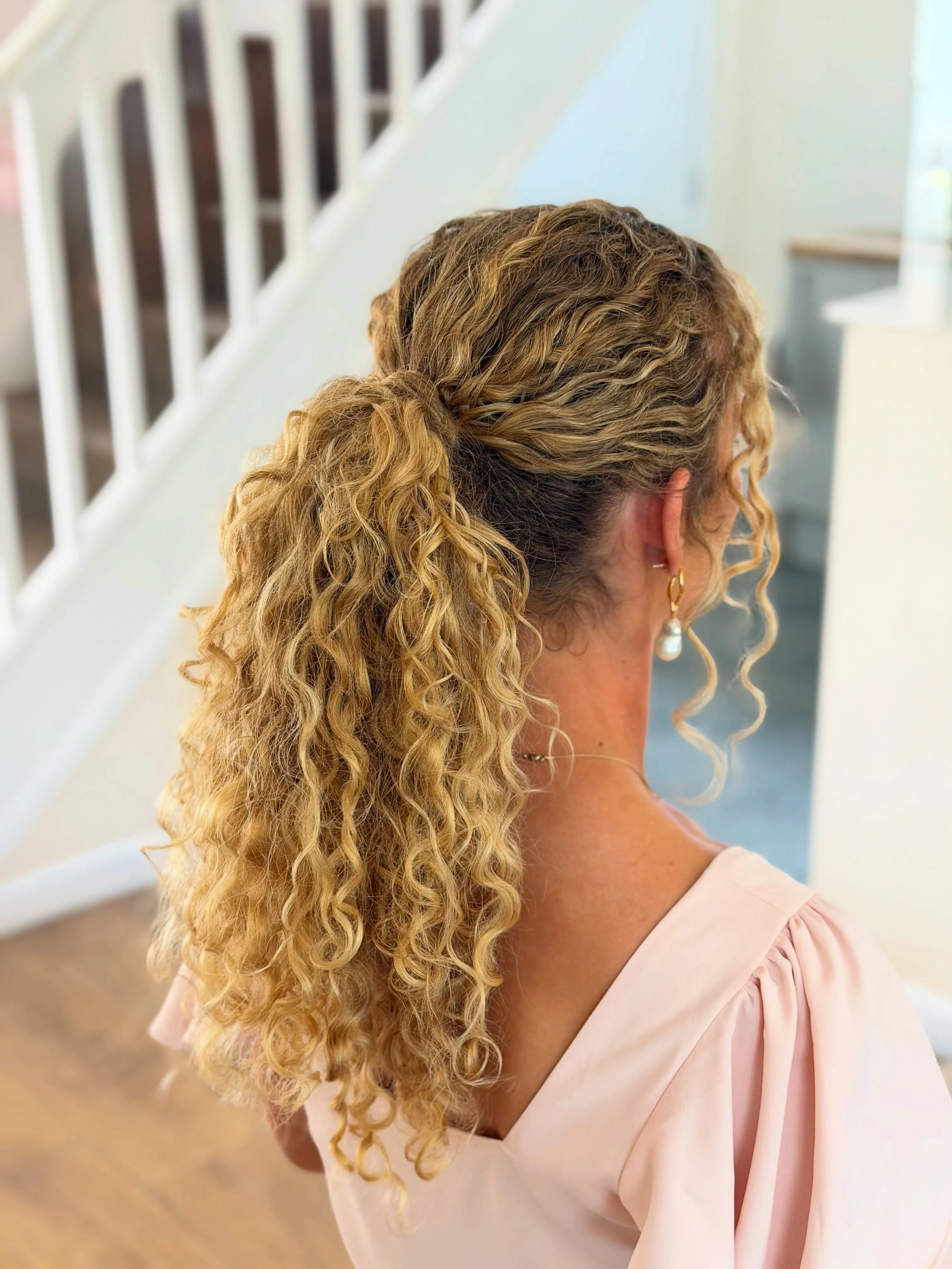 Braided curly ponytail with defined long curls