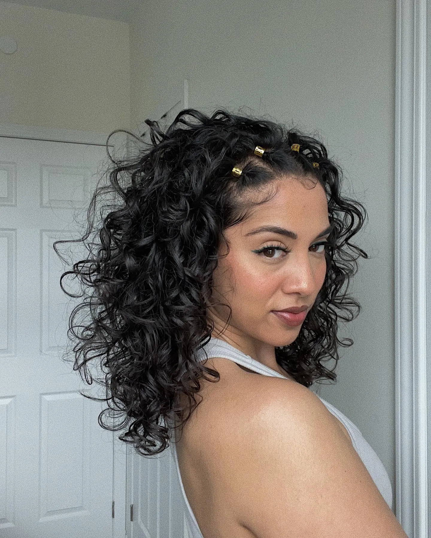 Loose shoulder-length curls with small gold clips