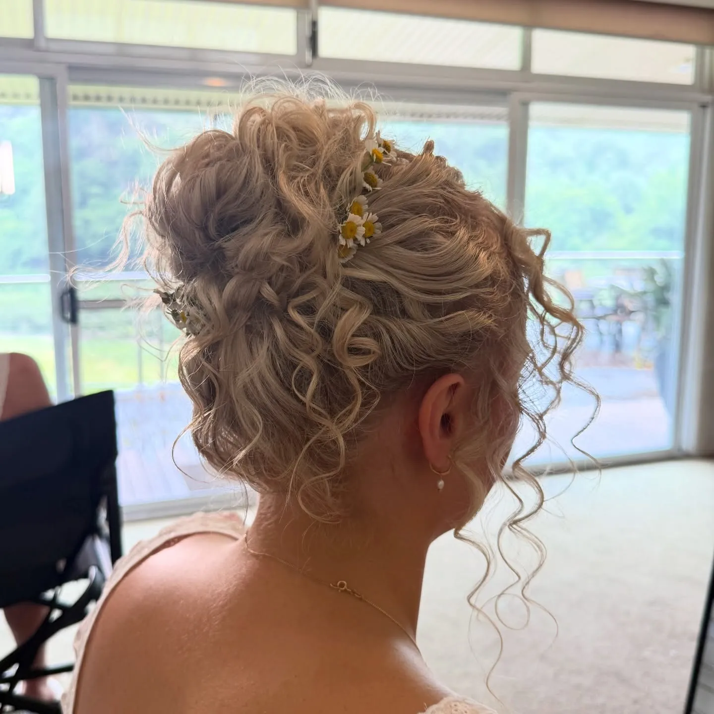High curly updo with small floral hair pins