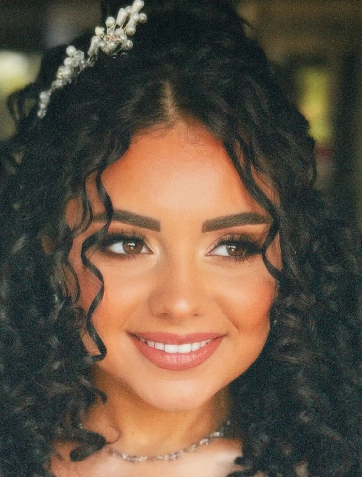 Center-parted curls with a jeweled hair accessory
