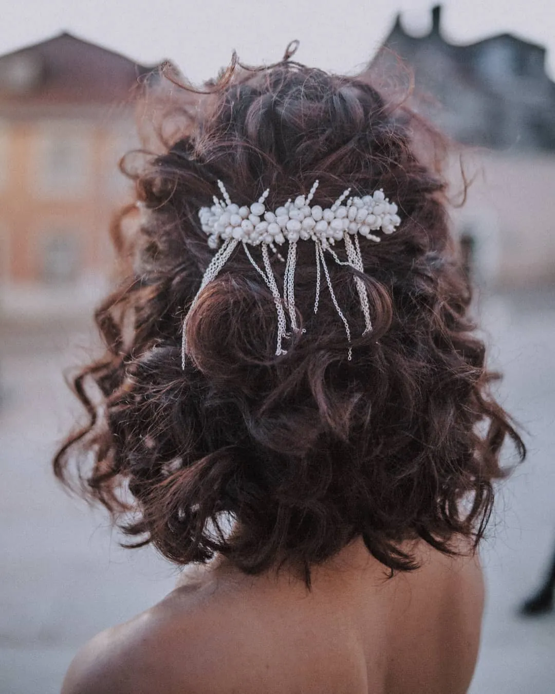 Half-up curls with a jeweled comb at the back