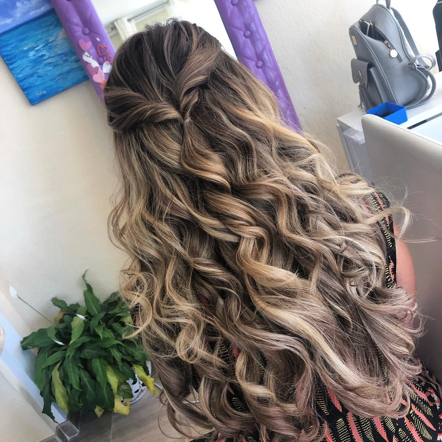 Long curls in a twisted half-up hairstyle