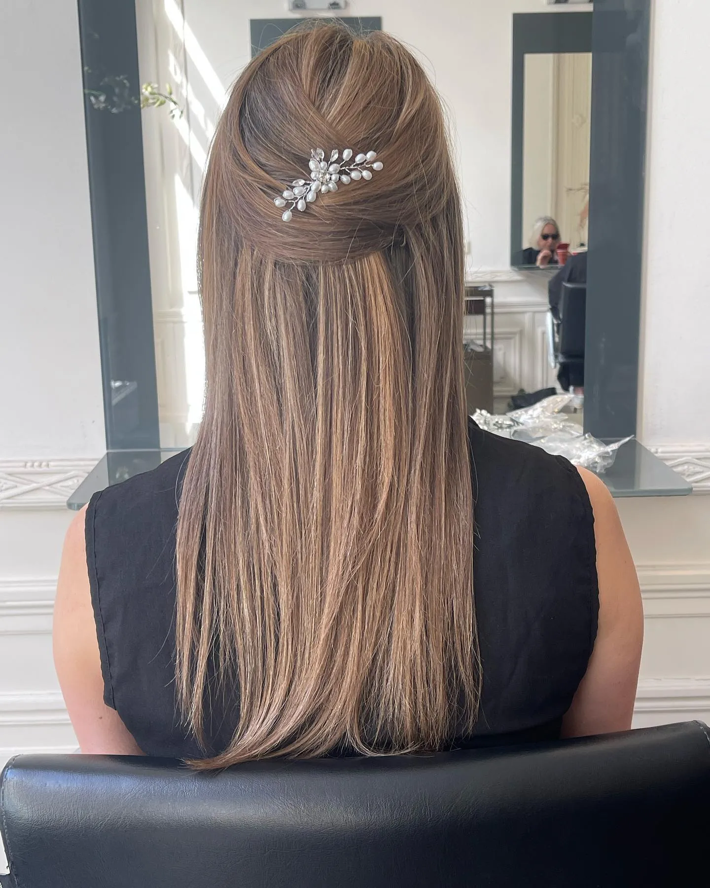 Straight half-up wedding hairstyle with pearl hair pin