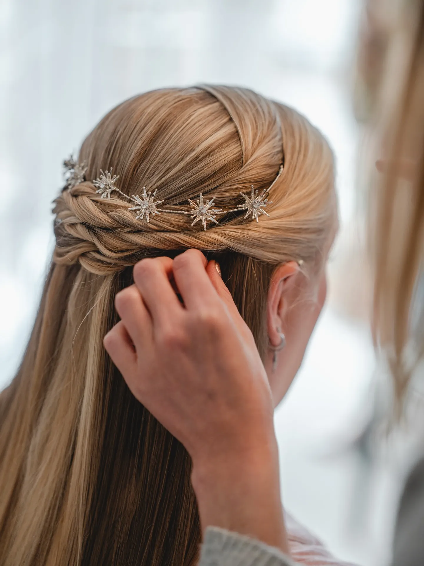 Straight half-up hair with twisted band and star pins