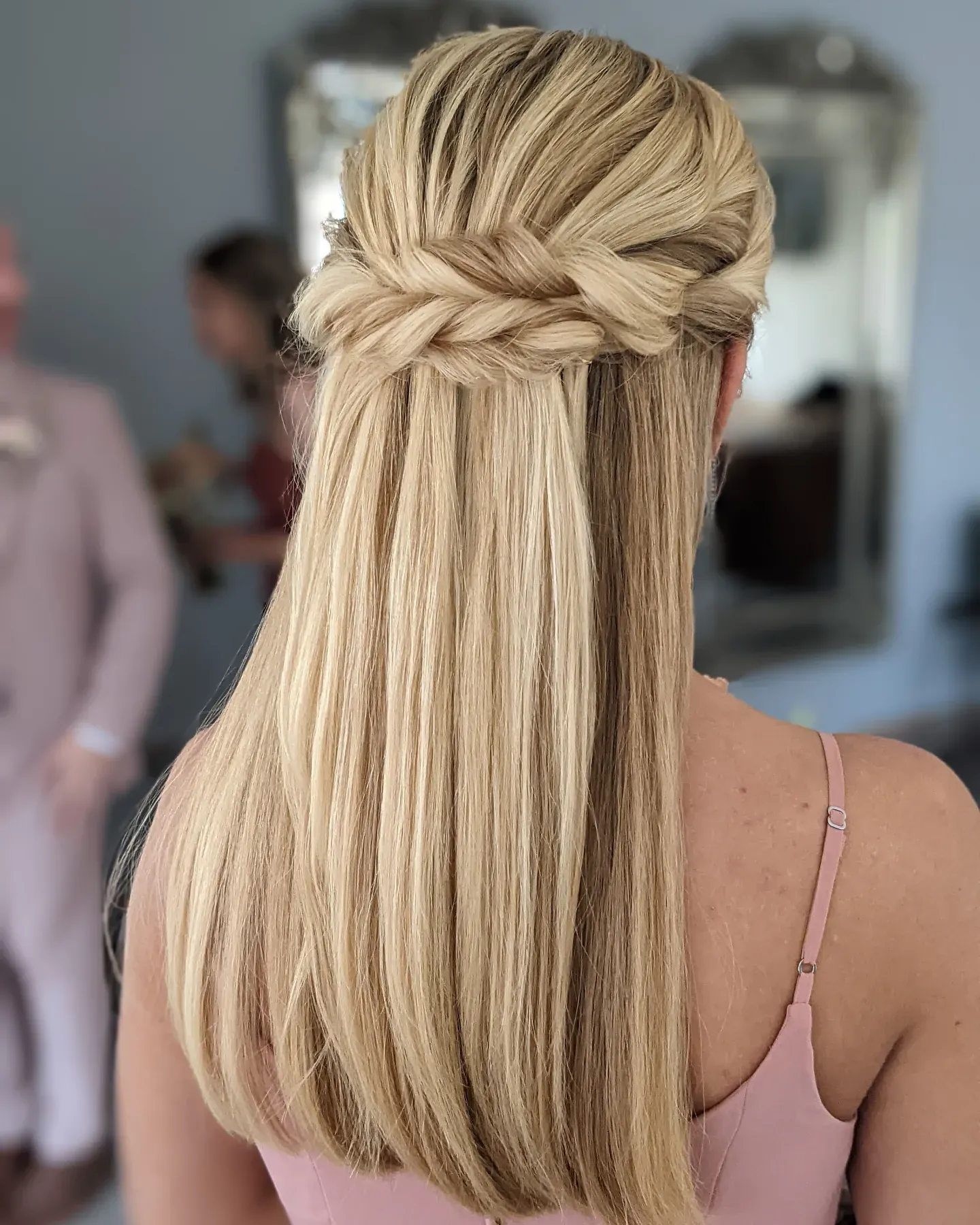 Long straight blonde hair with a wide braided half-up crown