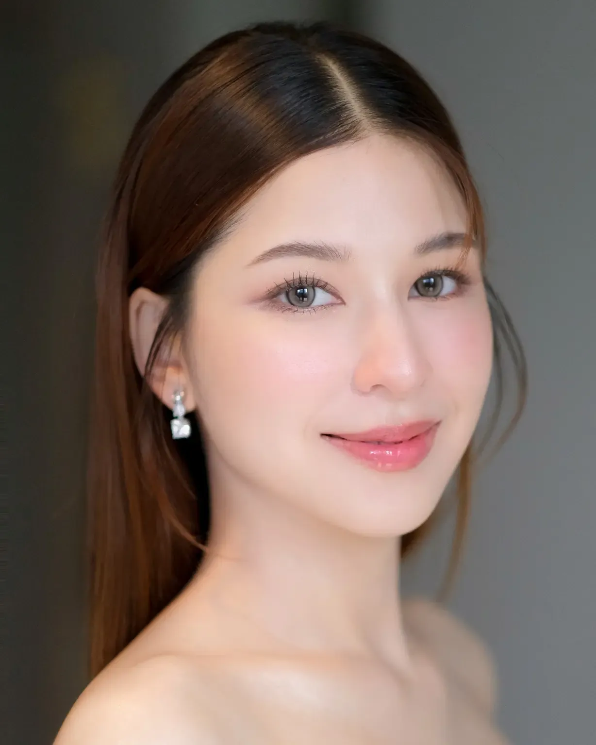 Sleek center-parted straight wedding hair tucked behind ears