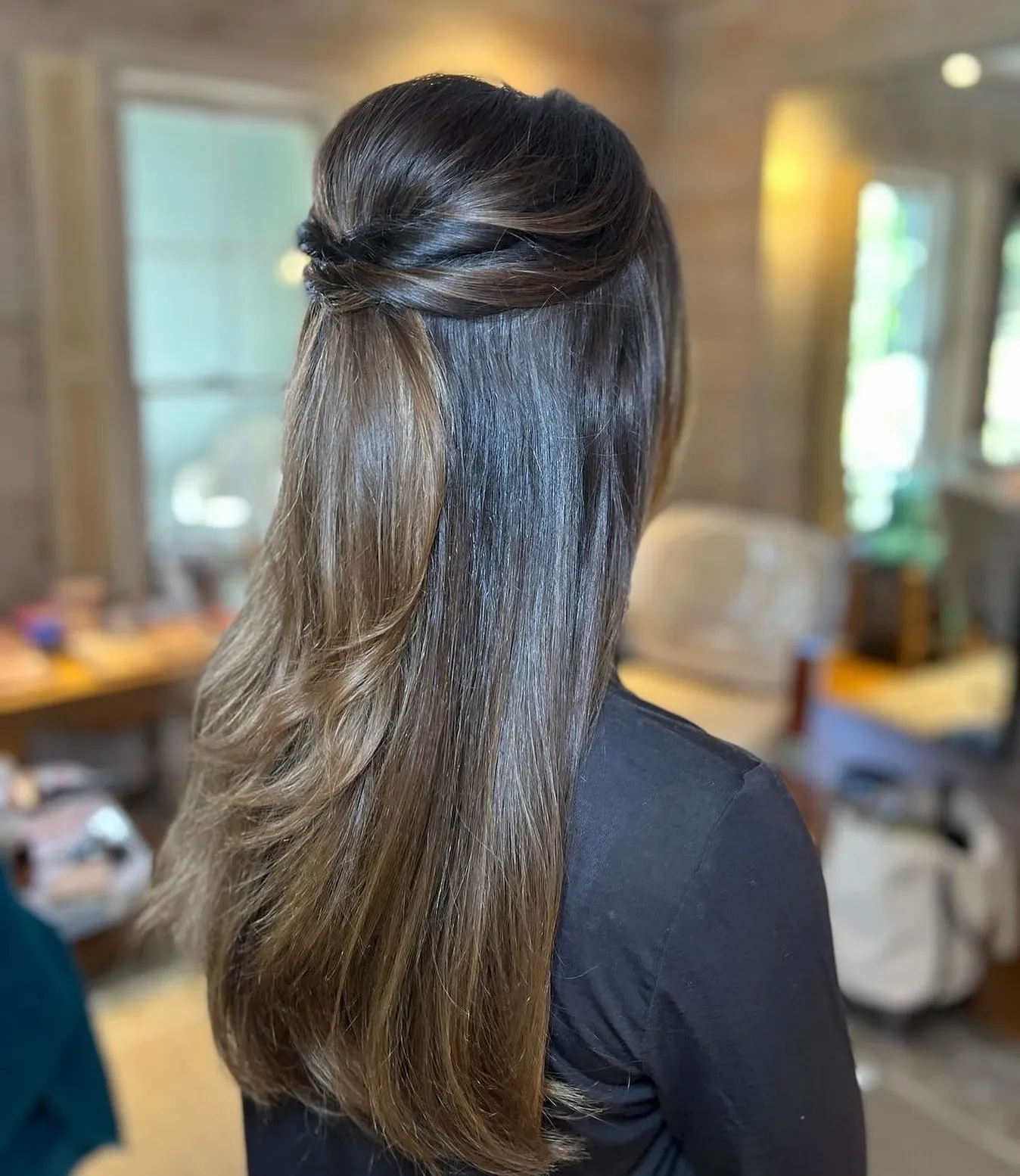 Long straight hair with a low twisted half-up section