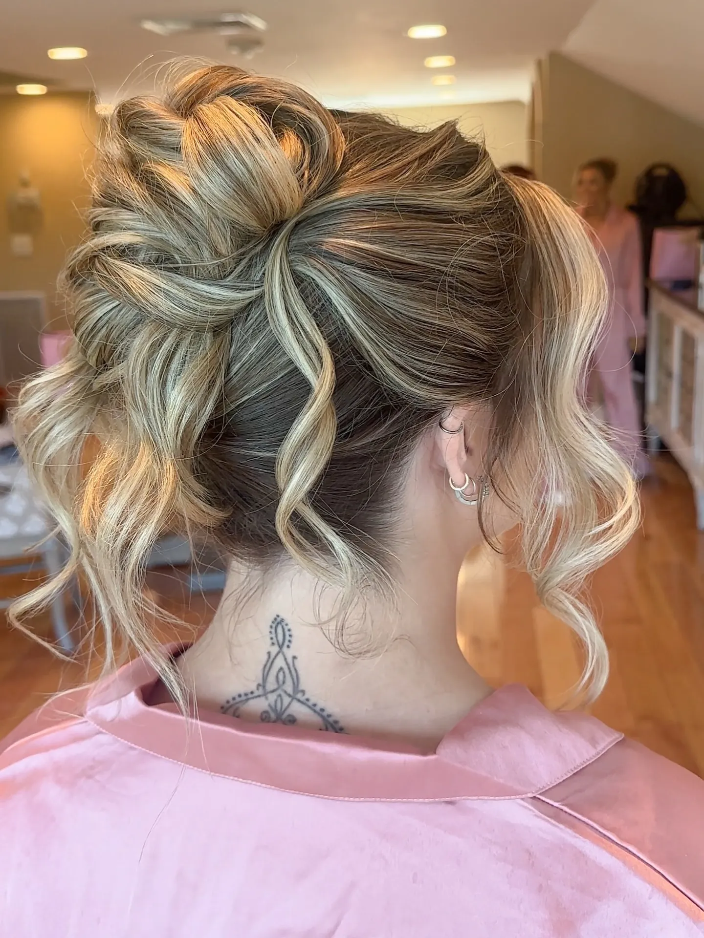Textured curled updo with loose highlighted tendrils