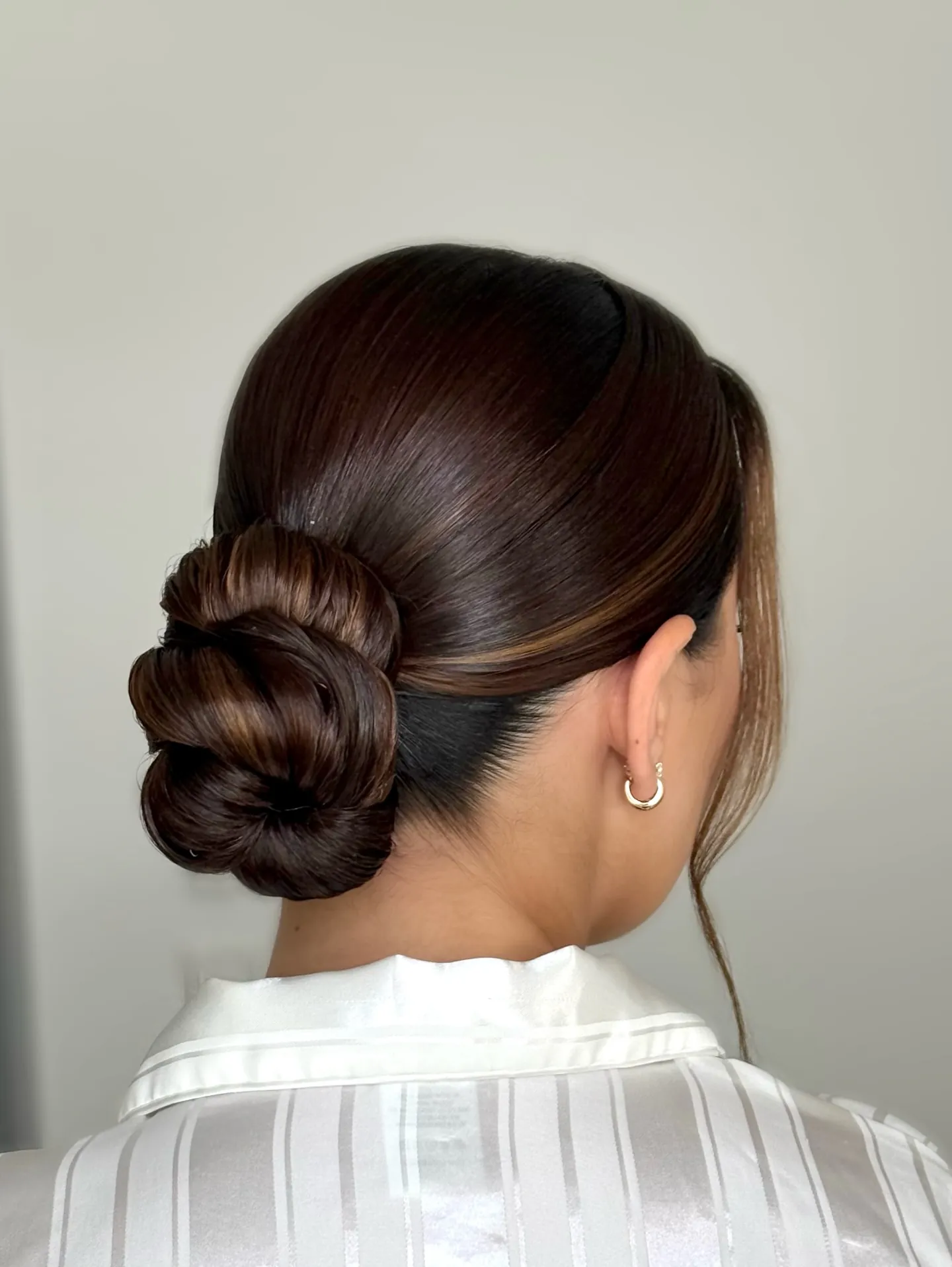 Sleek brunette low knotted bun