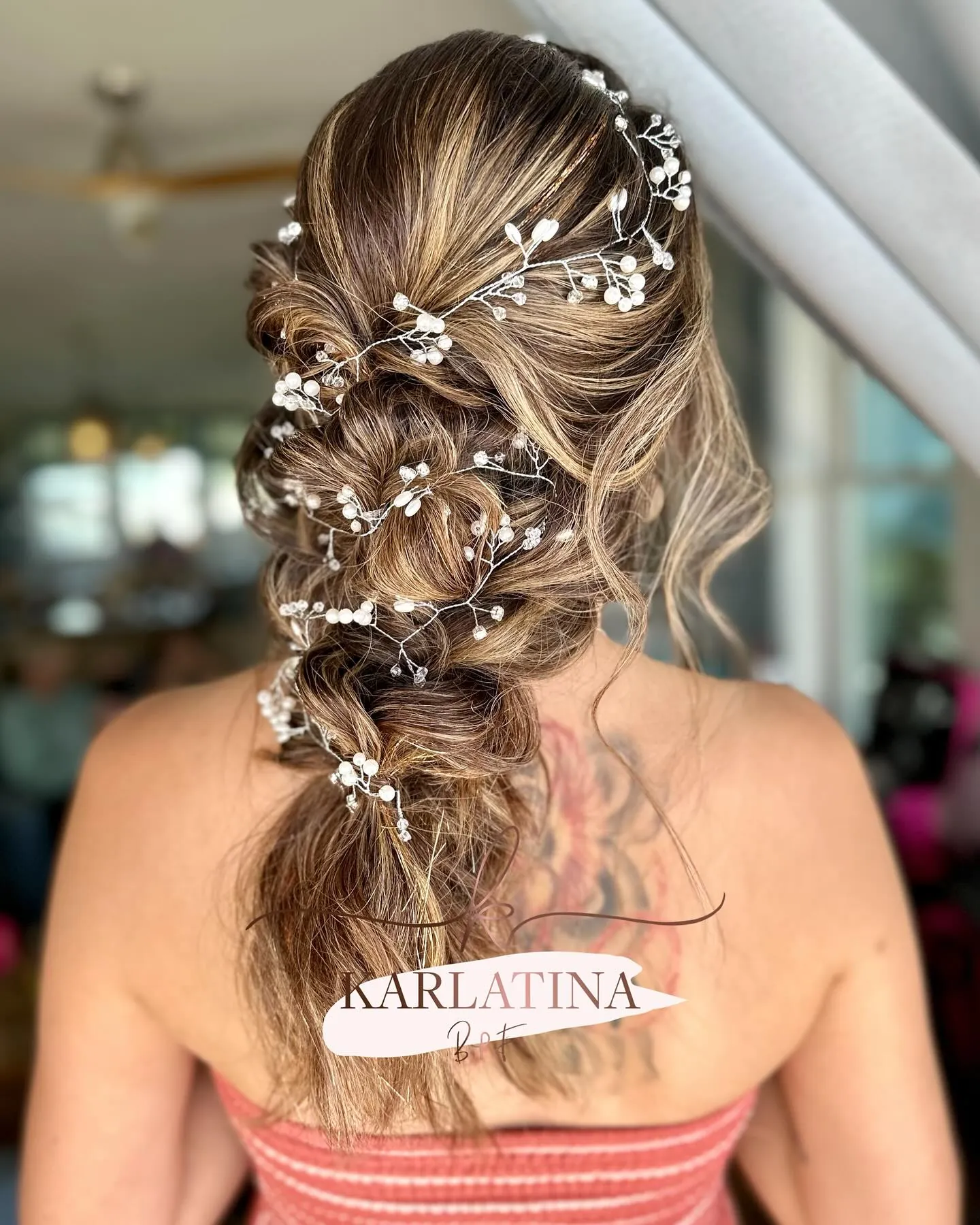 Textured bridal braid with delicate white floral hair vine