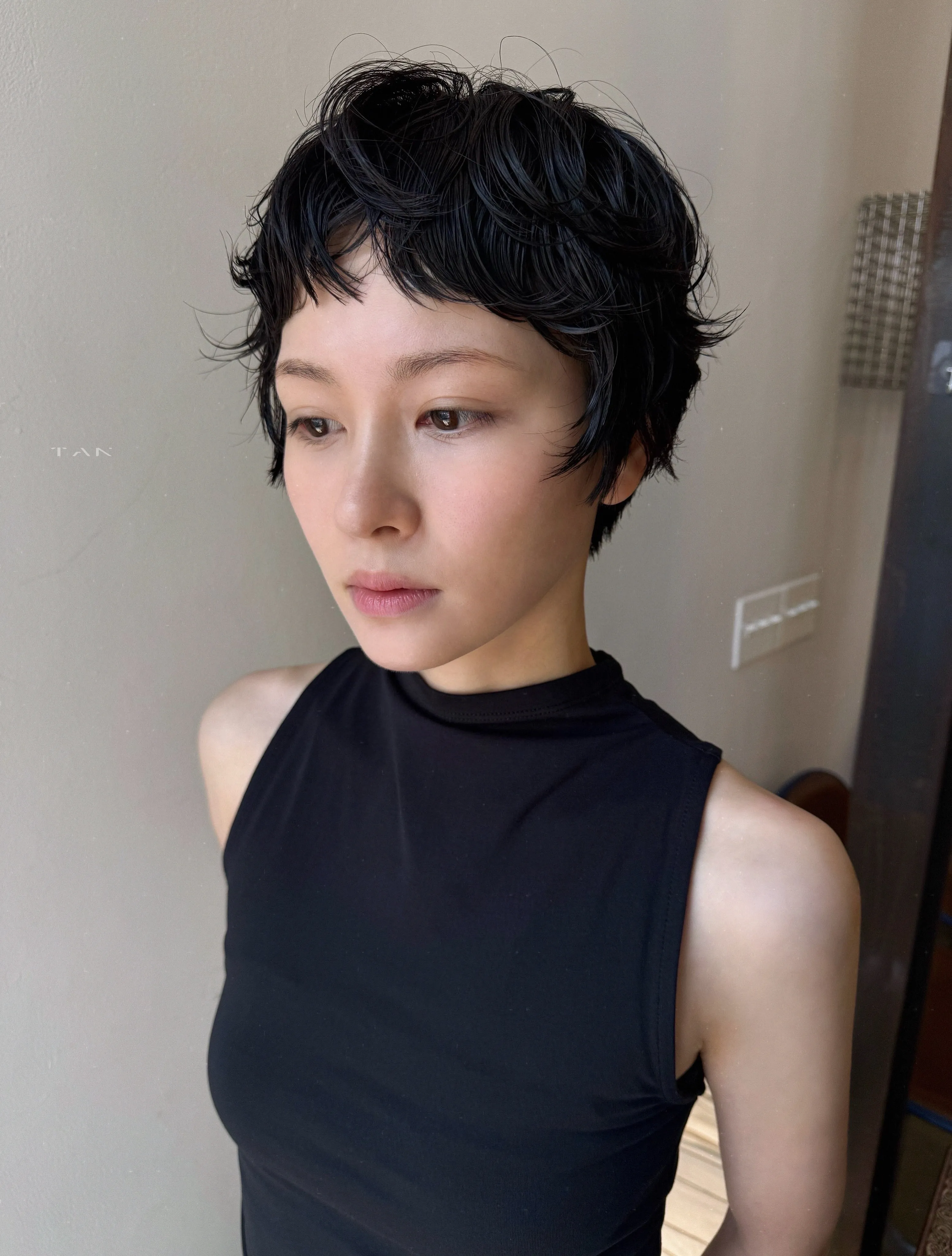 Short black pixie with sculpted glossy waves