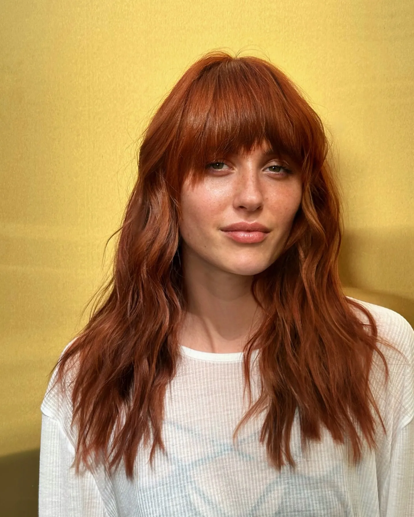 Long copper-red waves with a full fringe and softly textured ends