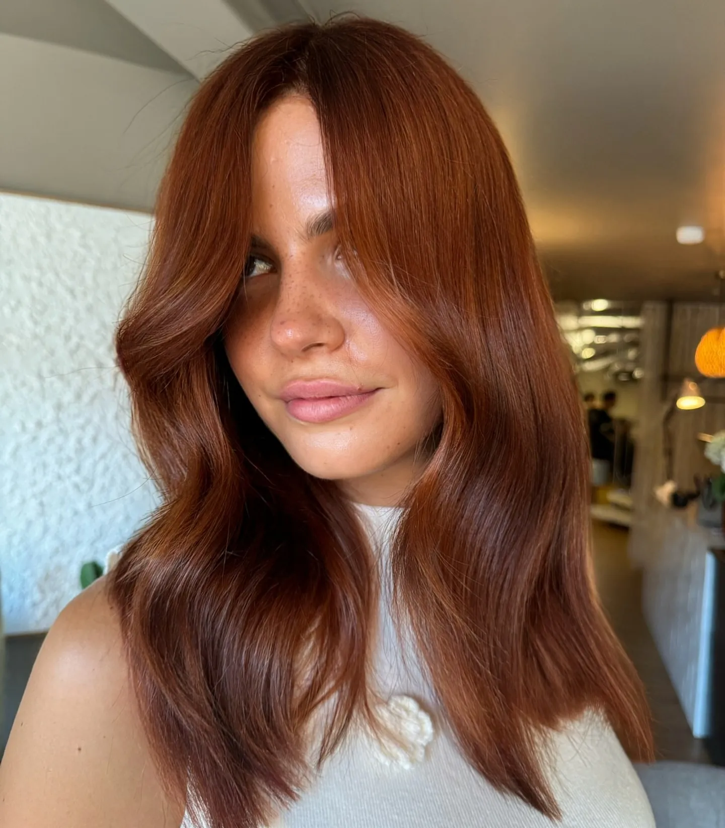 Long smooth copper hair with a center part and broad soft waves